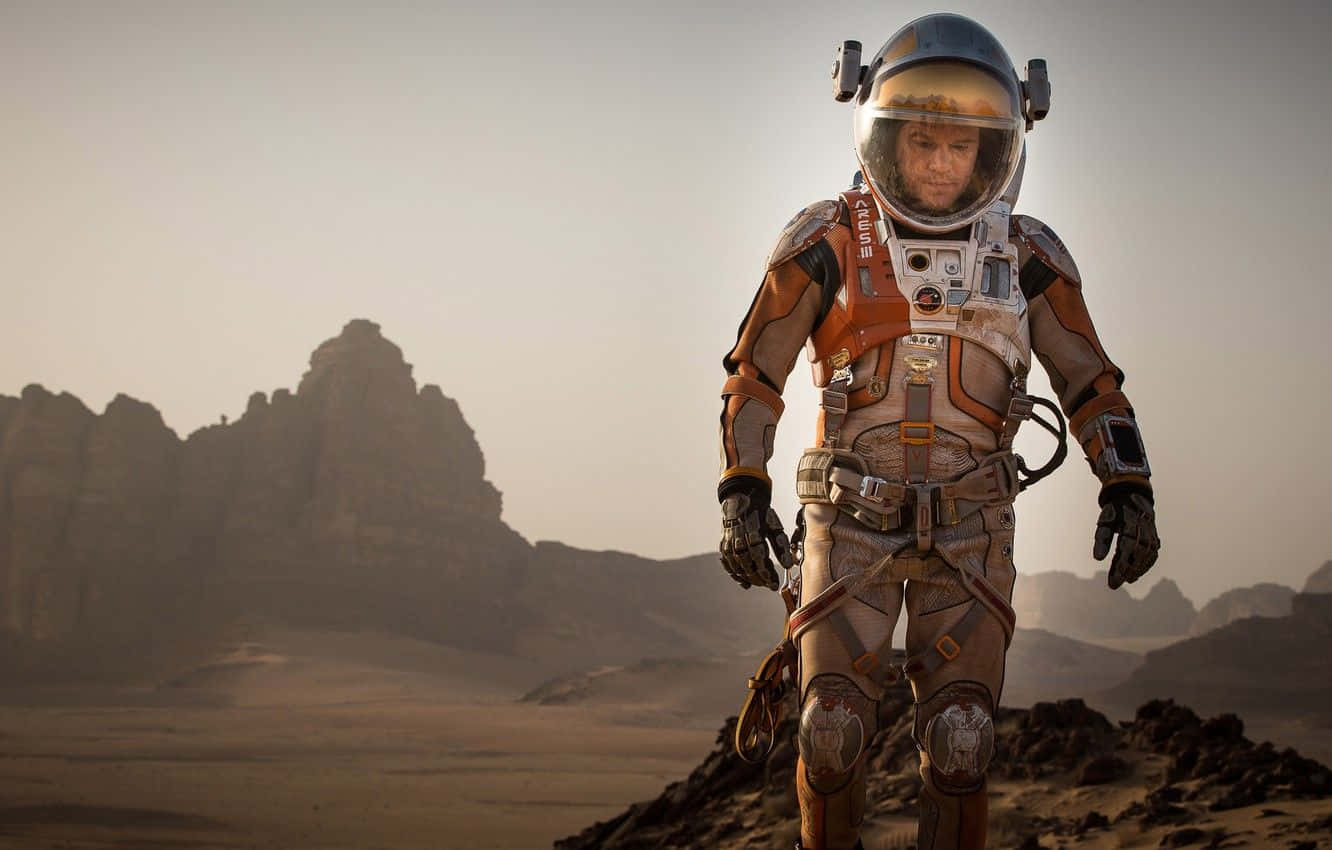 Astronaut Standing On The Mars Surface During A Mission In The Martian Movie Background