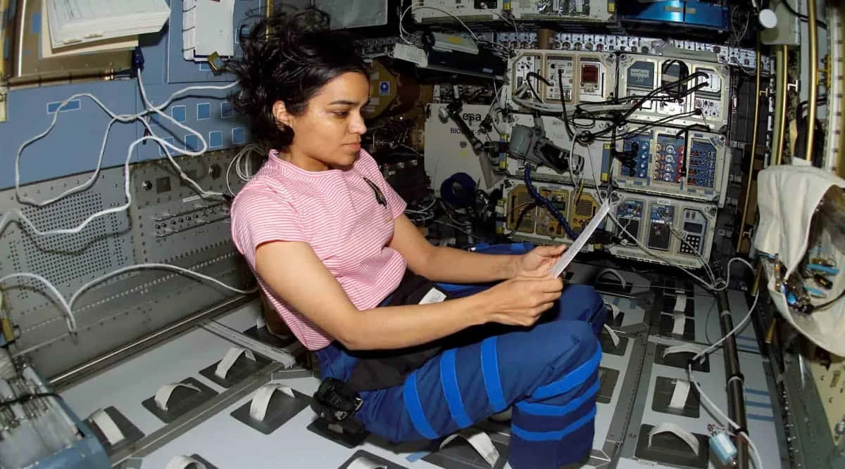 Astronaut Working Onboard Space Shuttle Background