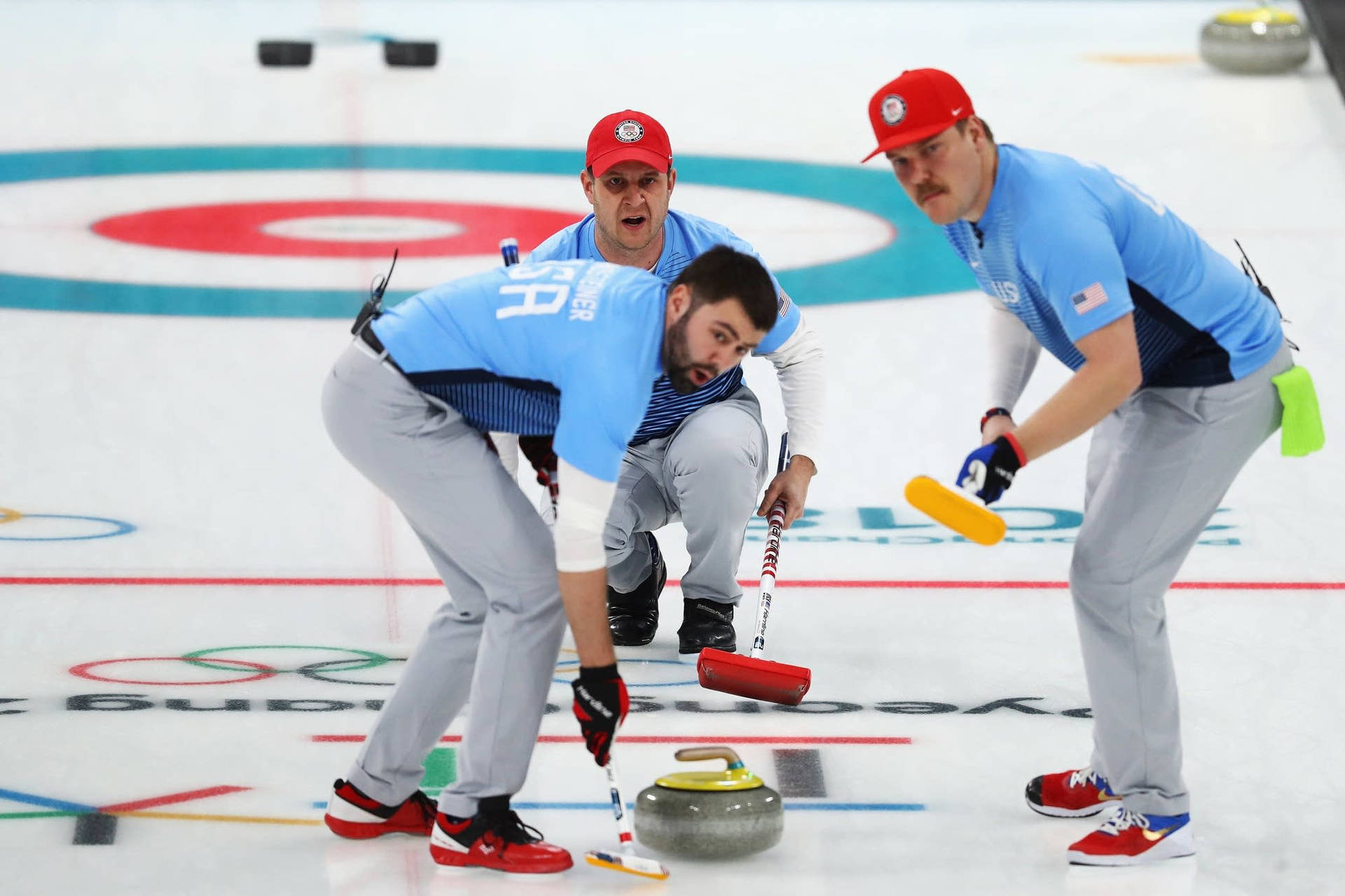 Athletes Curling The Stone On The Ice Background