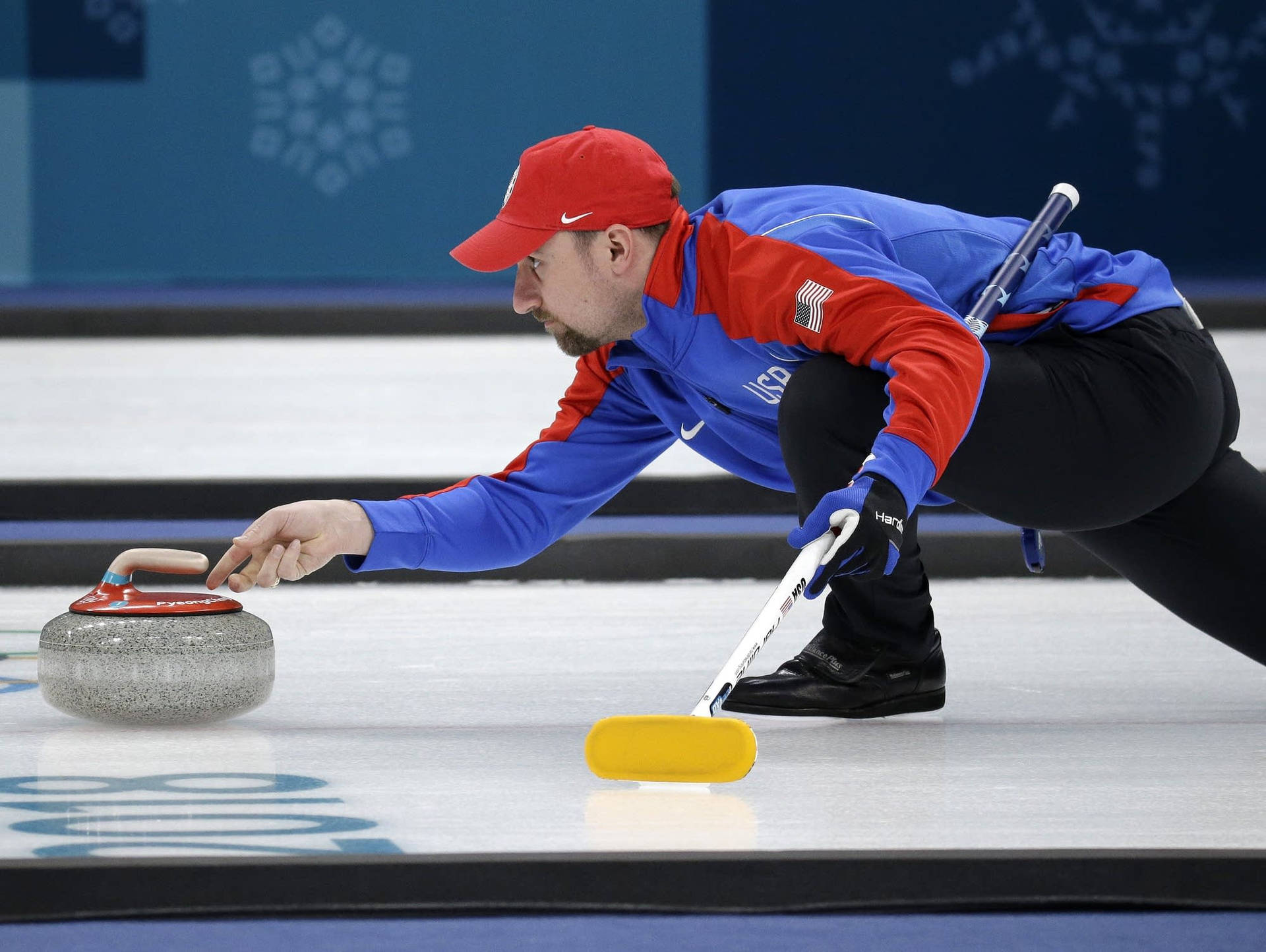 Athletes Sliding The Stones In Curling Background