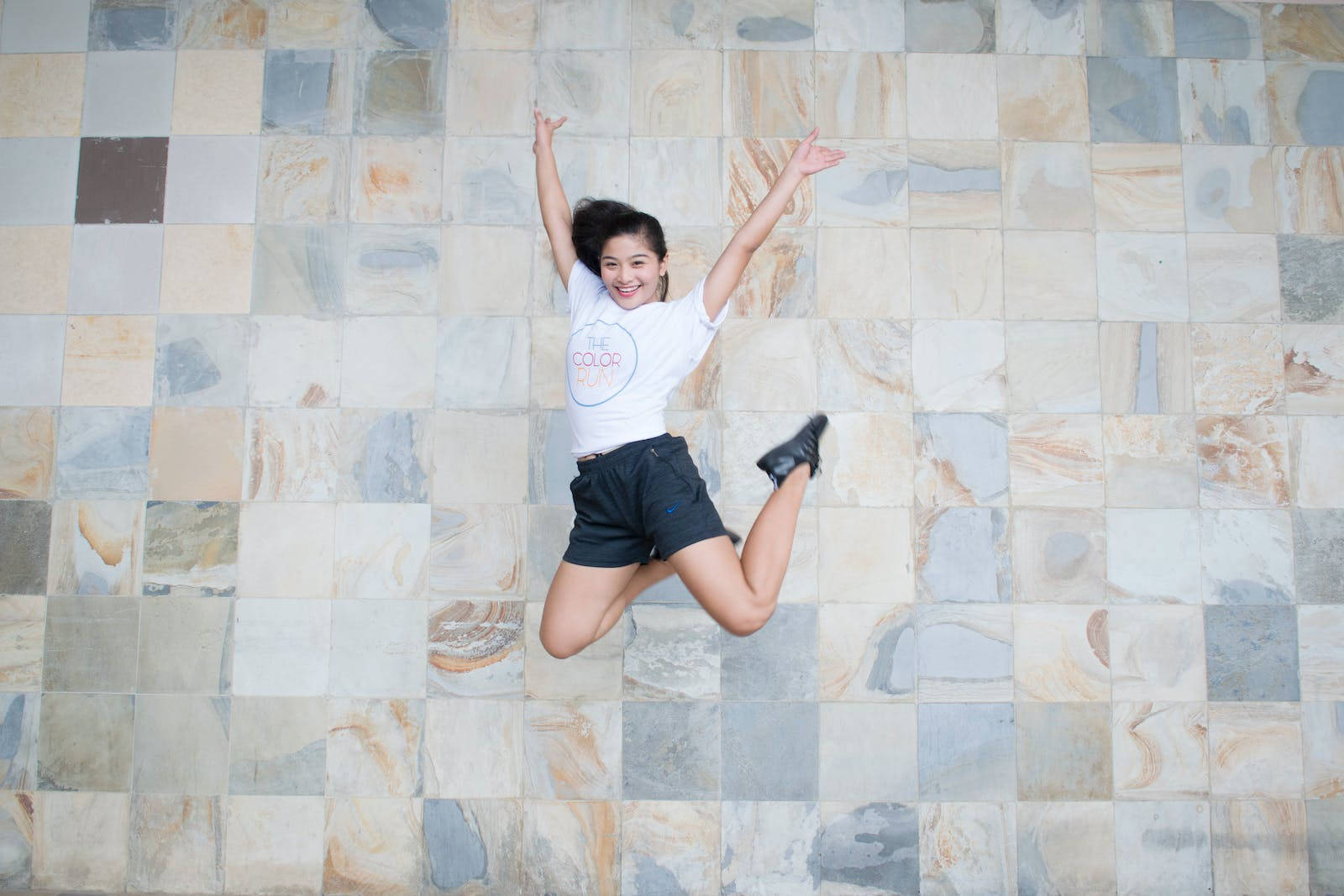 Athletic Jumping Against Tile Background
