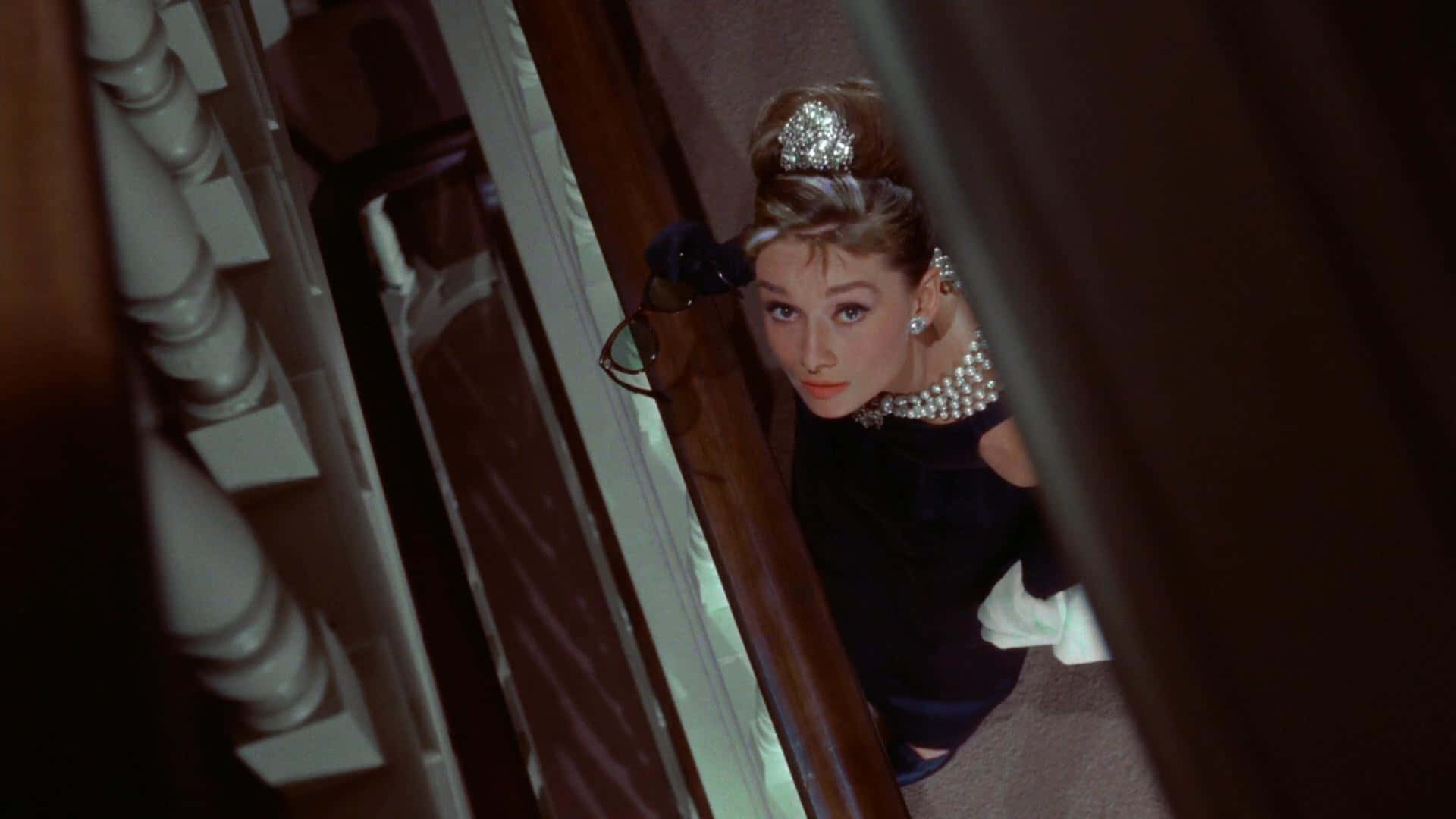 Audrey Hepburn In Her Iconic Role As Holly Golightly In The 1961 Classic, Breakfast At Tiffany's Background