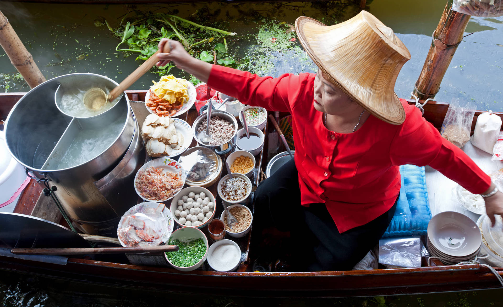 Authentic Flavors Of Bangkok - A Food Stall At A Floating Market Background