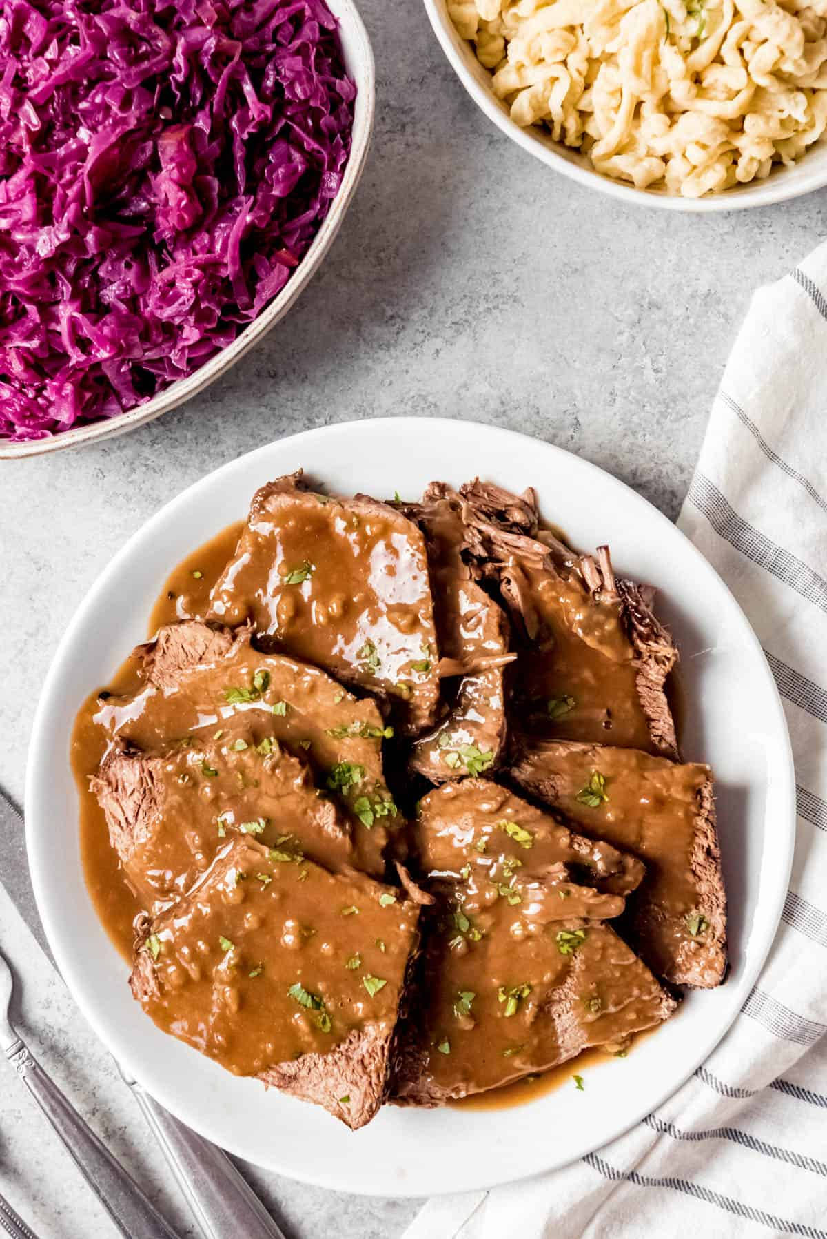 Authentic German Sauerbraten With Spaetzle And Red Cabbage Background