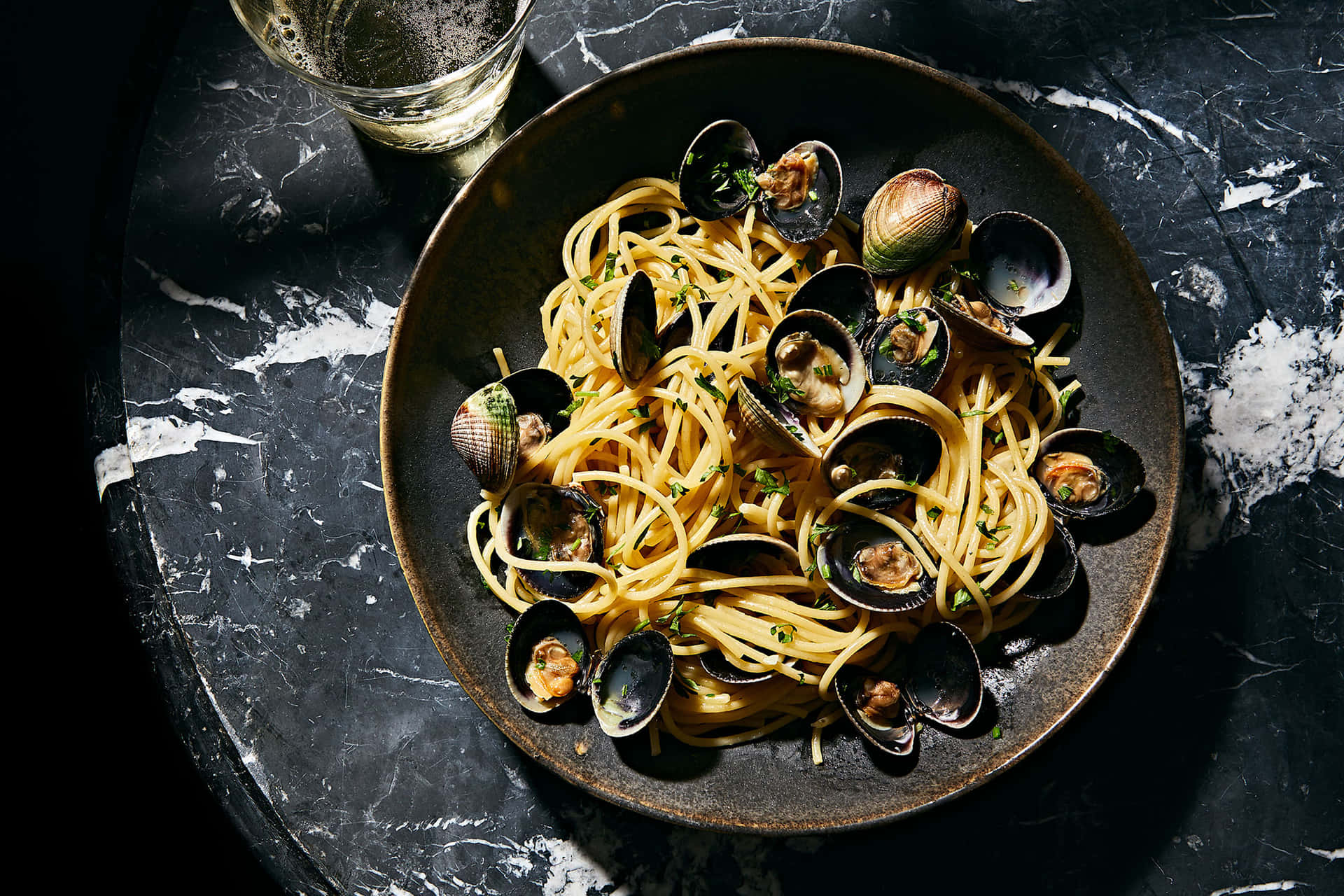 Authentic Italian Spaghetti Alla Vongole Served On A Black Plate Background