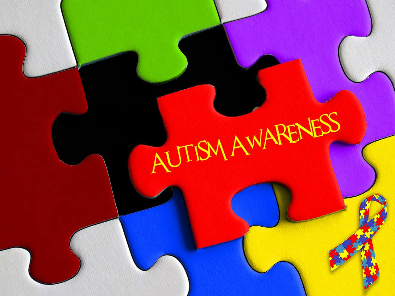 Autism Awareness Puzzle Pieces With The Word Autism Background