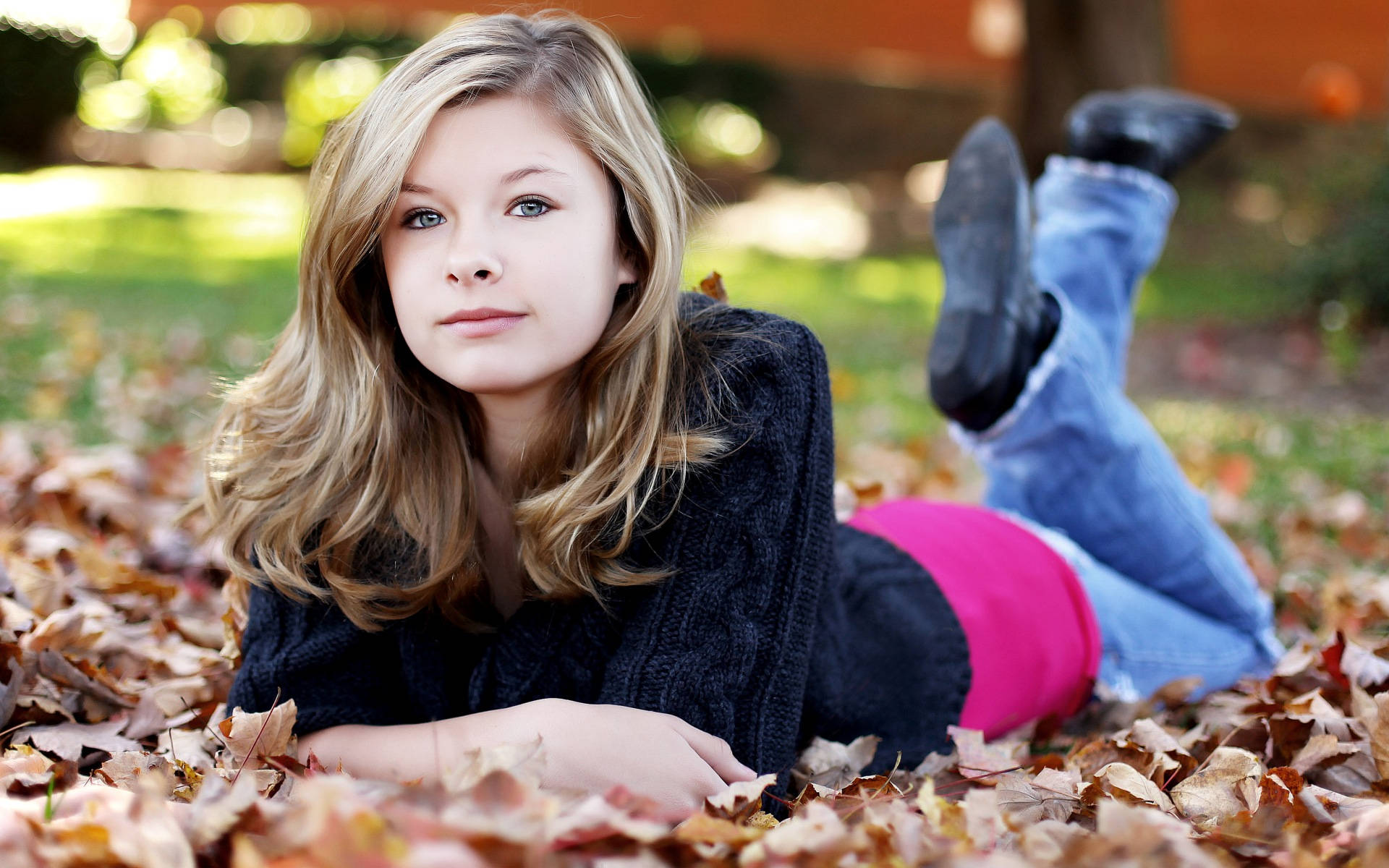 Autumn Bliss - A Beautiful Teenage Girl Among Dried Leaves. Background