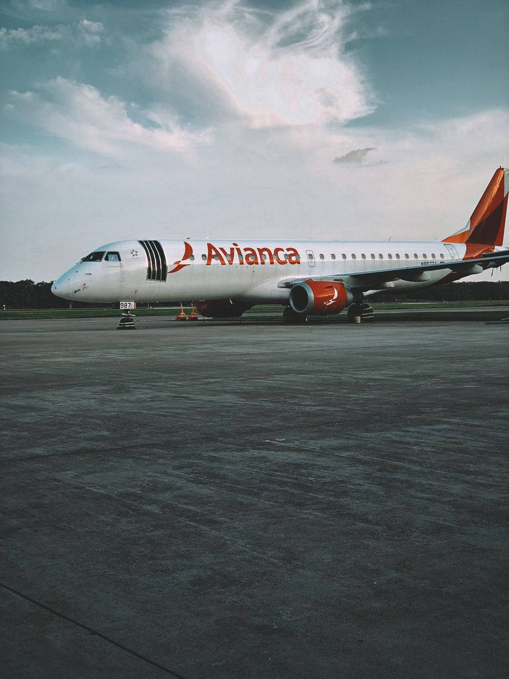 Avianca Airline Plane Beneath Cloudy Sky Background