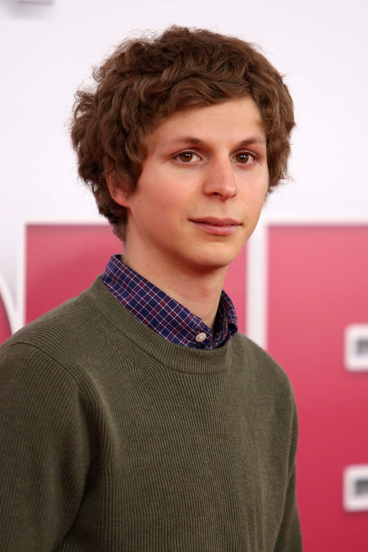 Award-winning Actor Michael Cera Posing For A Professional Photoshoot. Background