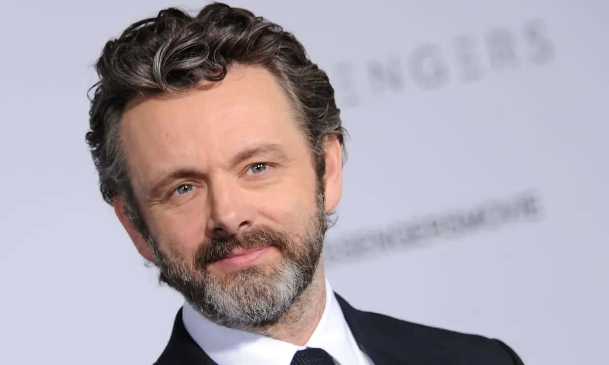 Award-winning Actor Michael Sheen In A Thoughtful Pose Background