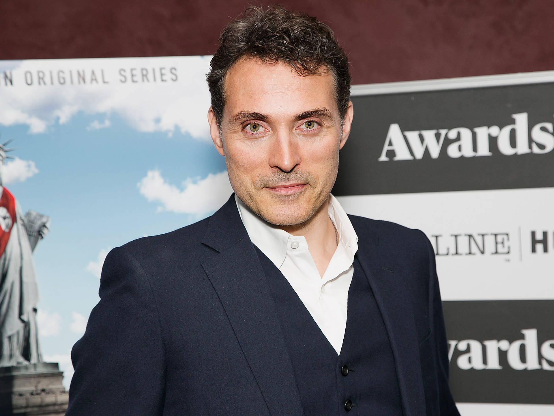 Award Winning Actor Rufus Sewell In A Stylish Suit Background