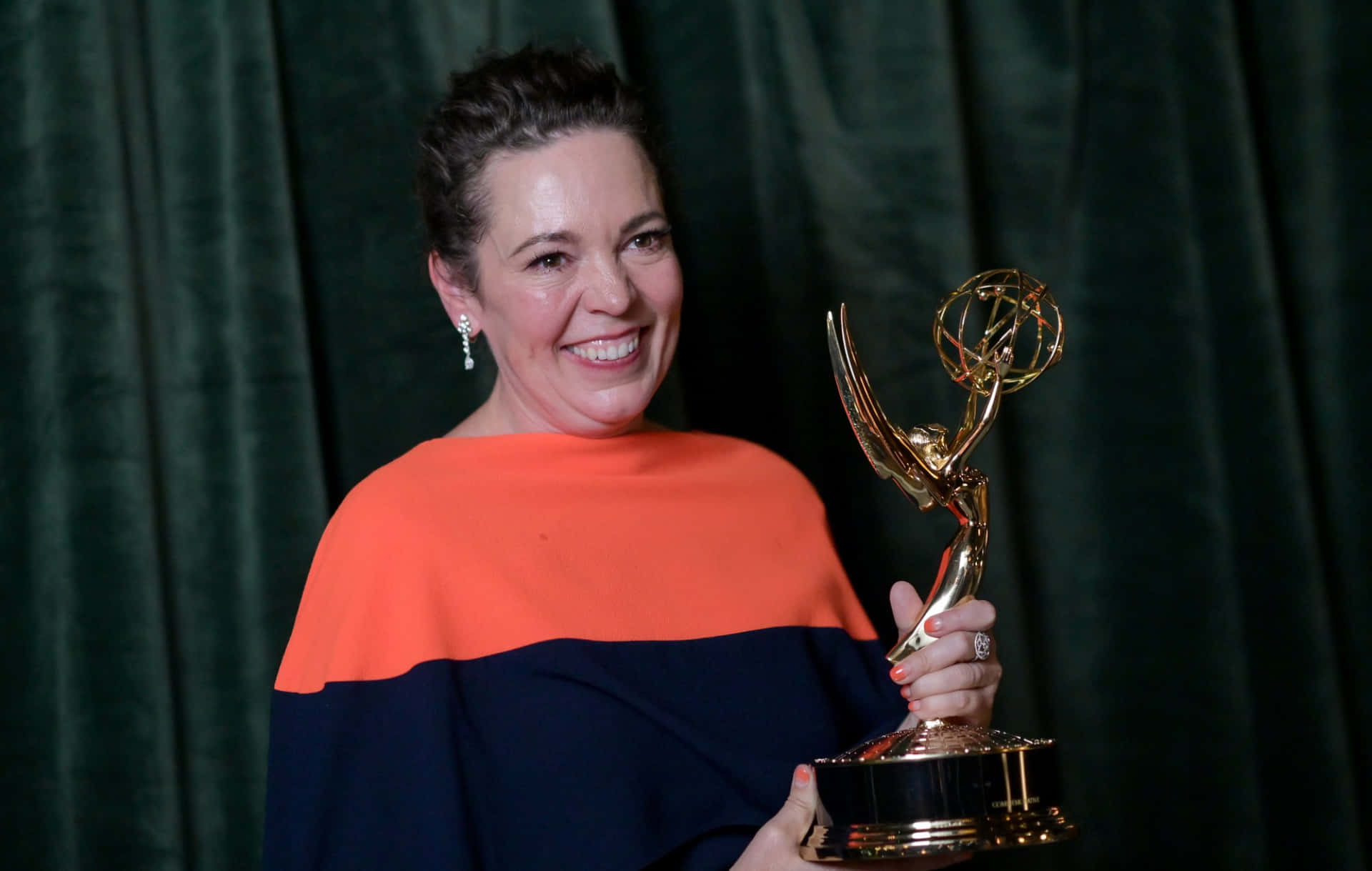 Award-winning Actress Olivia Colman Posing Elegantly Background