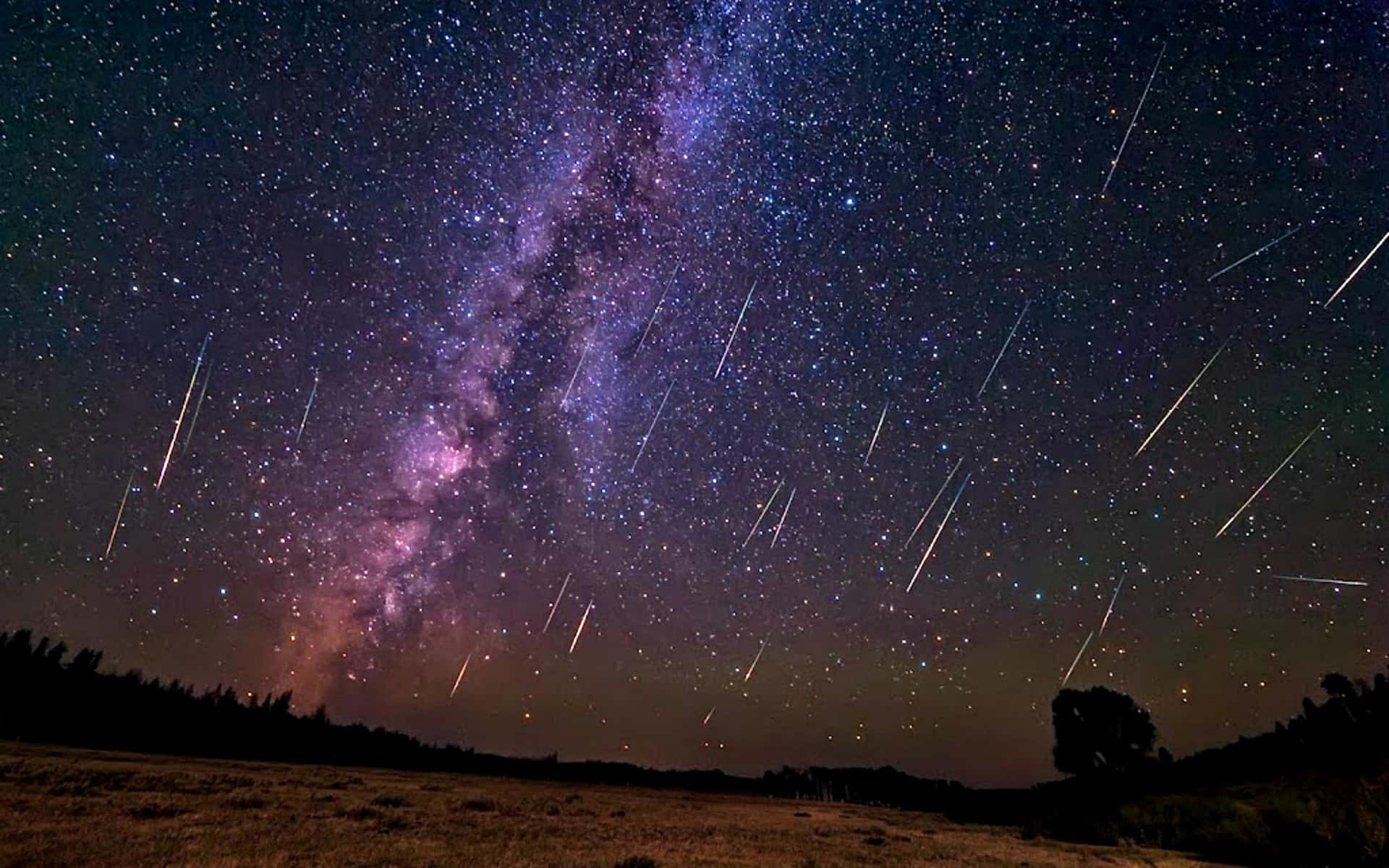 Awe-inspiring Meteor Shower In Night Sky Background