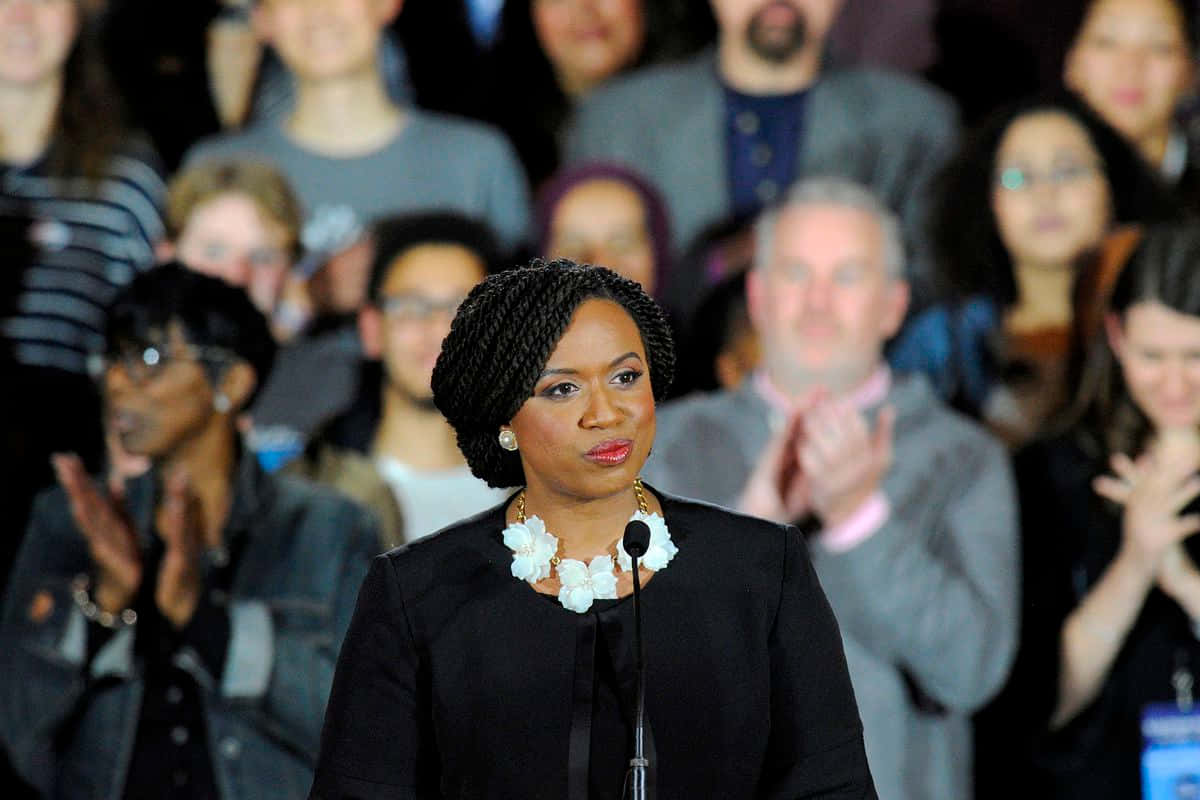 Ayanna Pressley Applauds Enthusiastically During Event Background