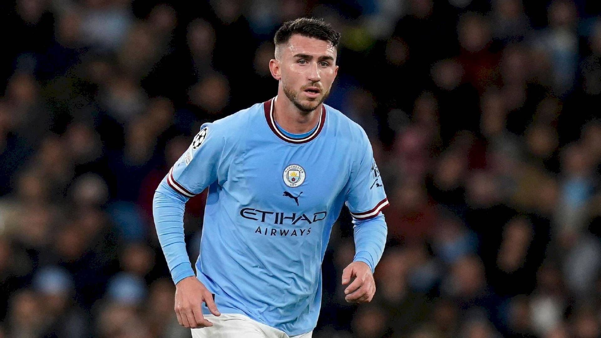 Aymeric Laporte Running In Blue Shirt Background