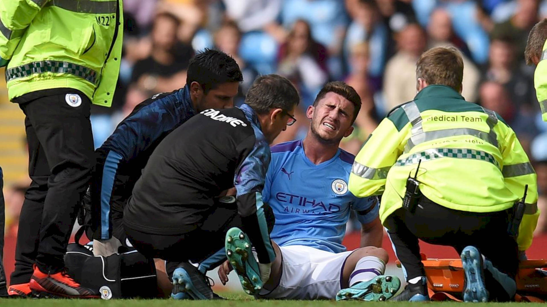 Aymeric Laporte Surrounded By Medics Background