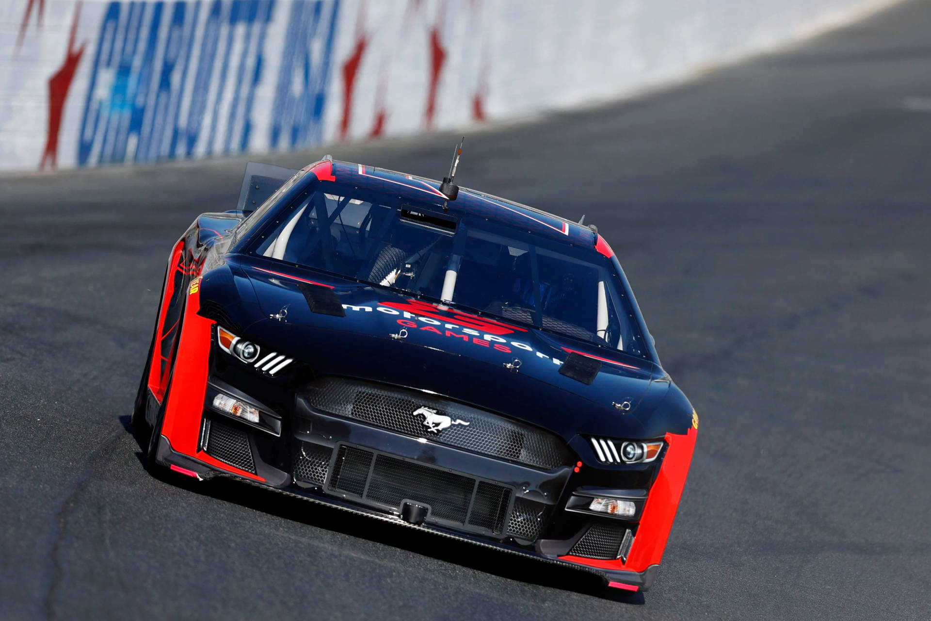 B.j. Mcleod Speeding The Ford Mustang In A Nascar Race Background