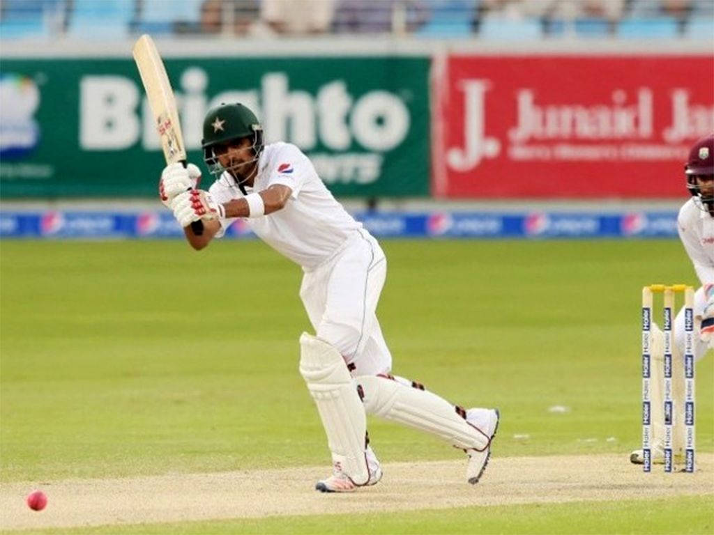 Babar Azam In White Cricket Uniform Background