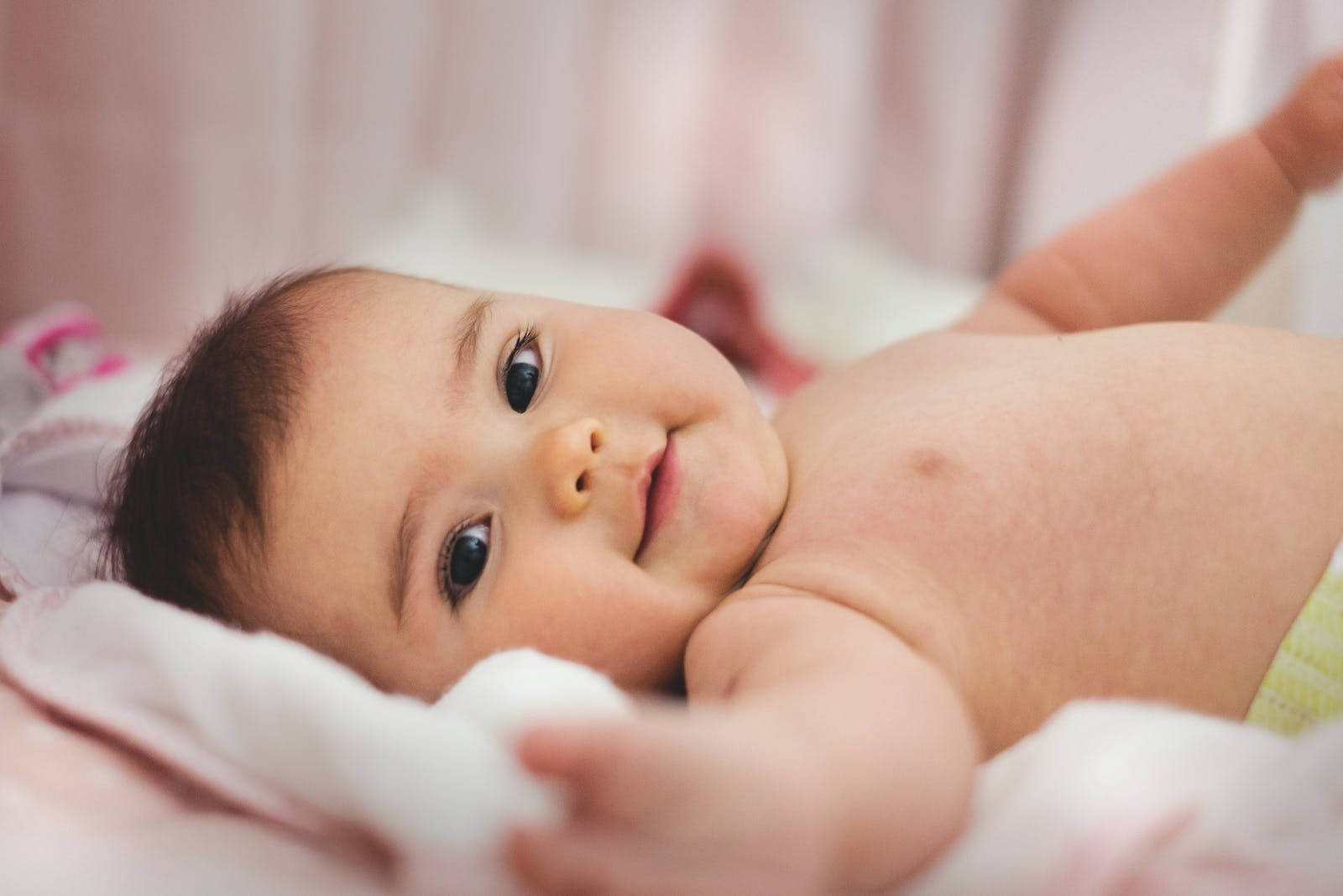 Baby Boy Laying On Bed Background