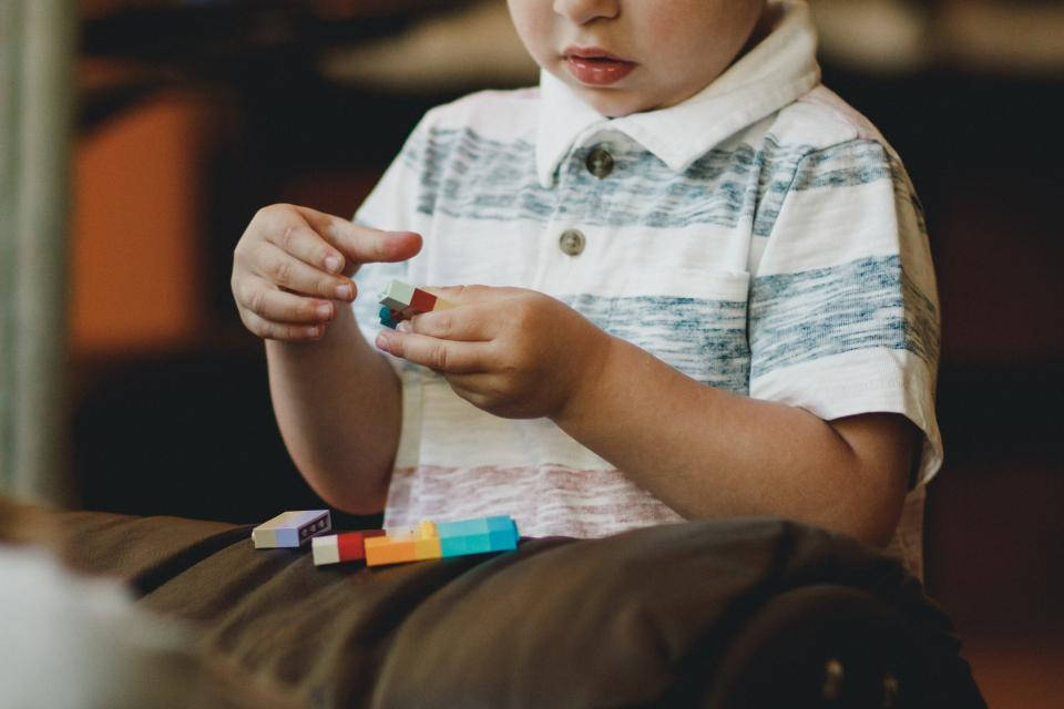 Baby Boy Playing With Lego Background