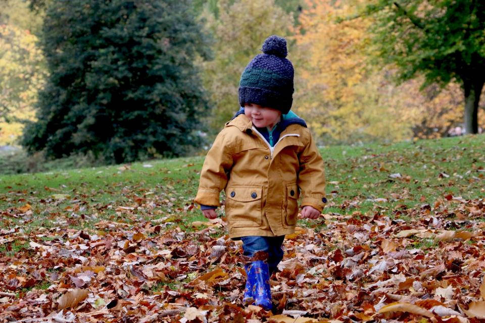 Baby Boy Wearing Cozy Brown Jacket Background