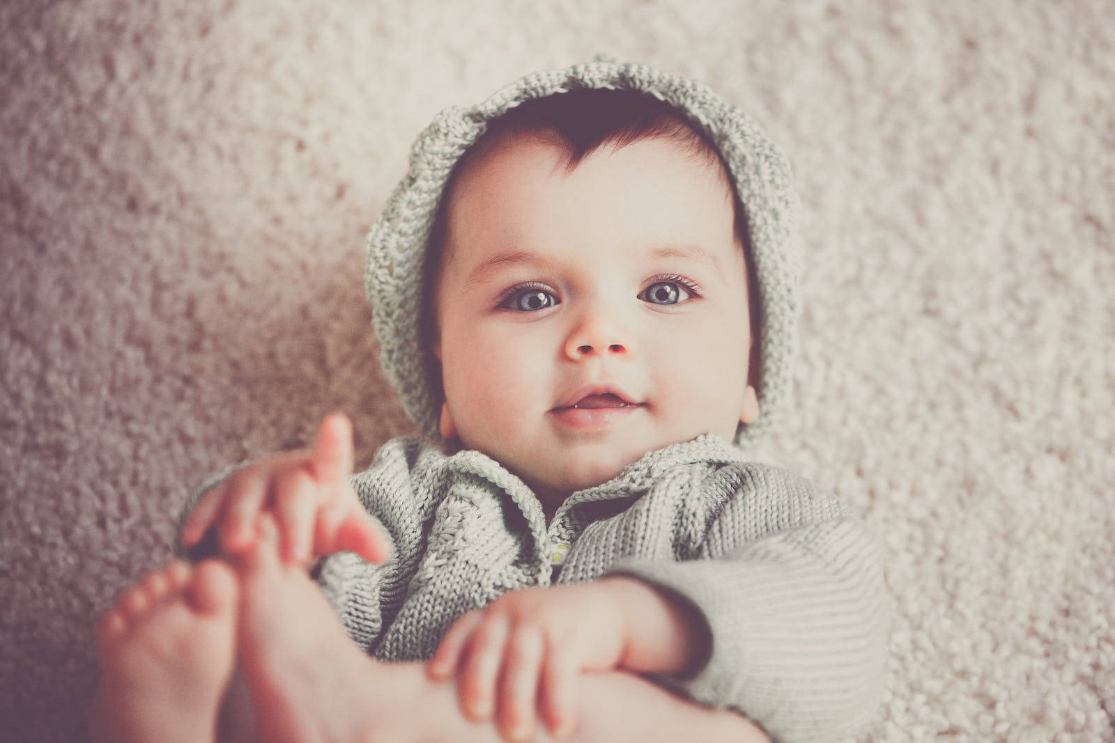 Baby Boy Wearing Gray Knitted Outfit Background
