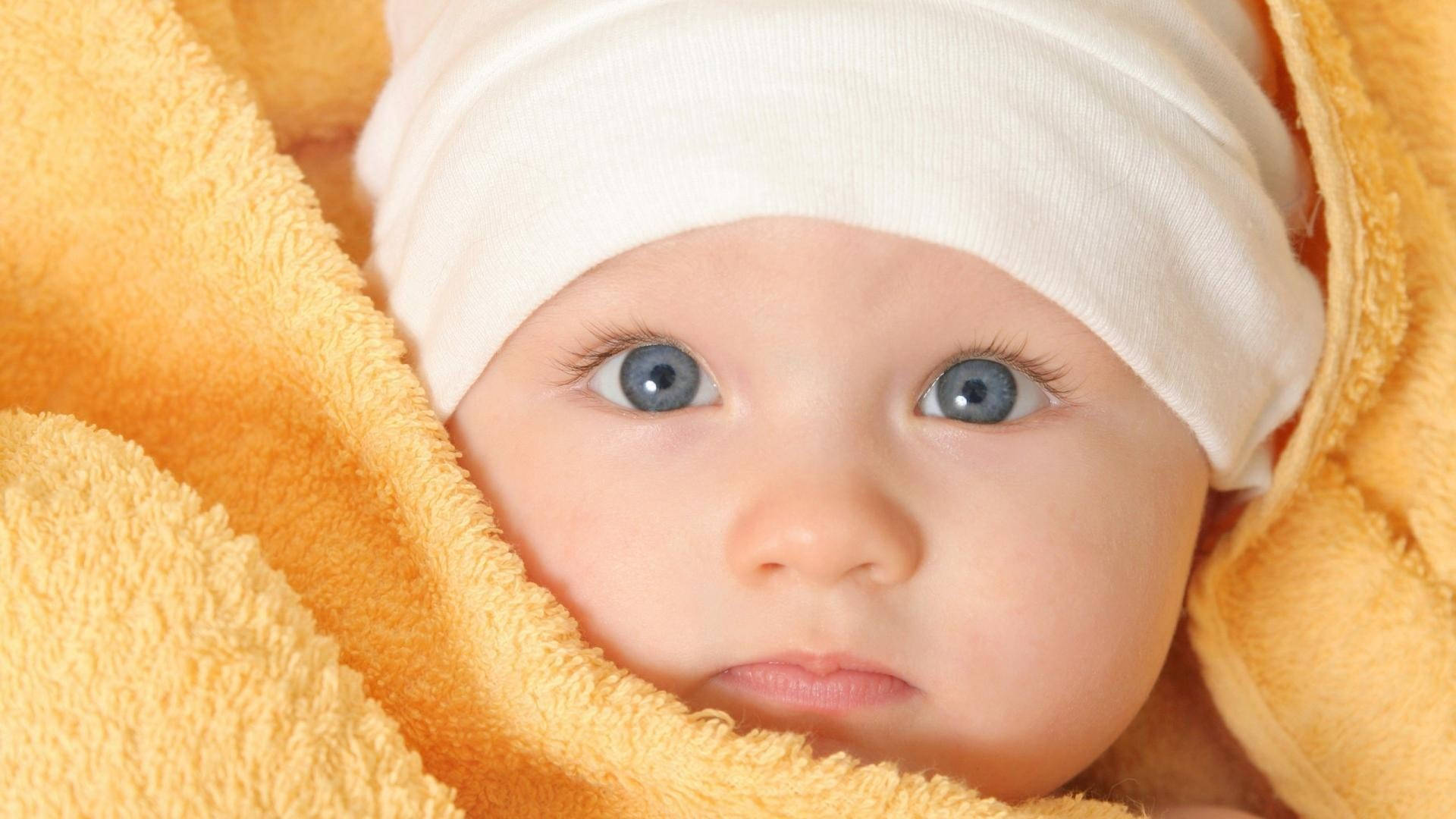 Baby Boy Wrapped In Yellow Towel Background