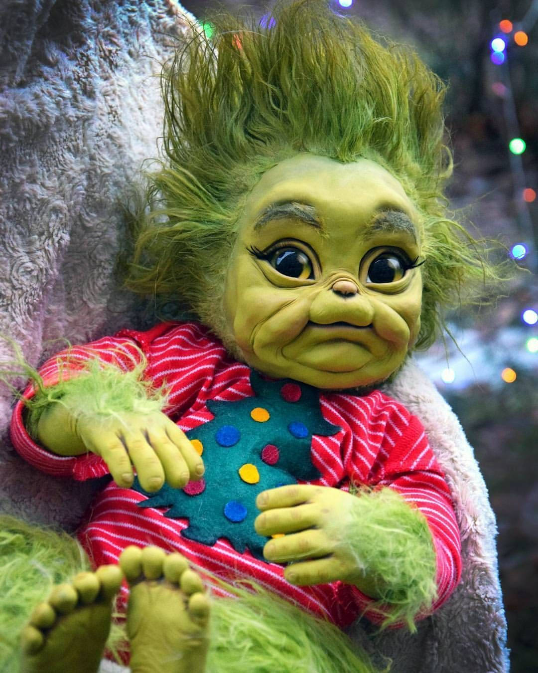 Baby Grinch In Onesies Christmas Attire Background