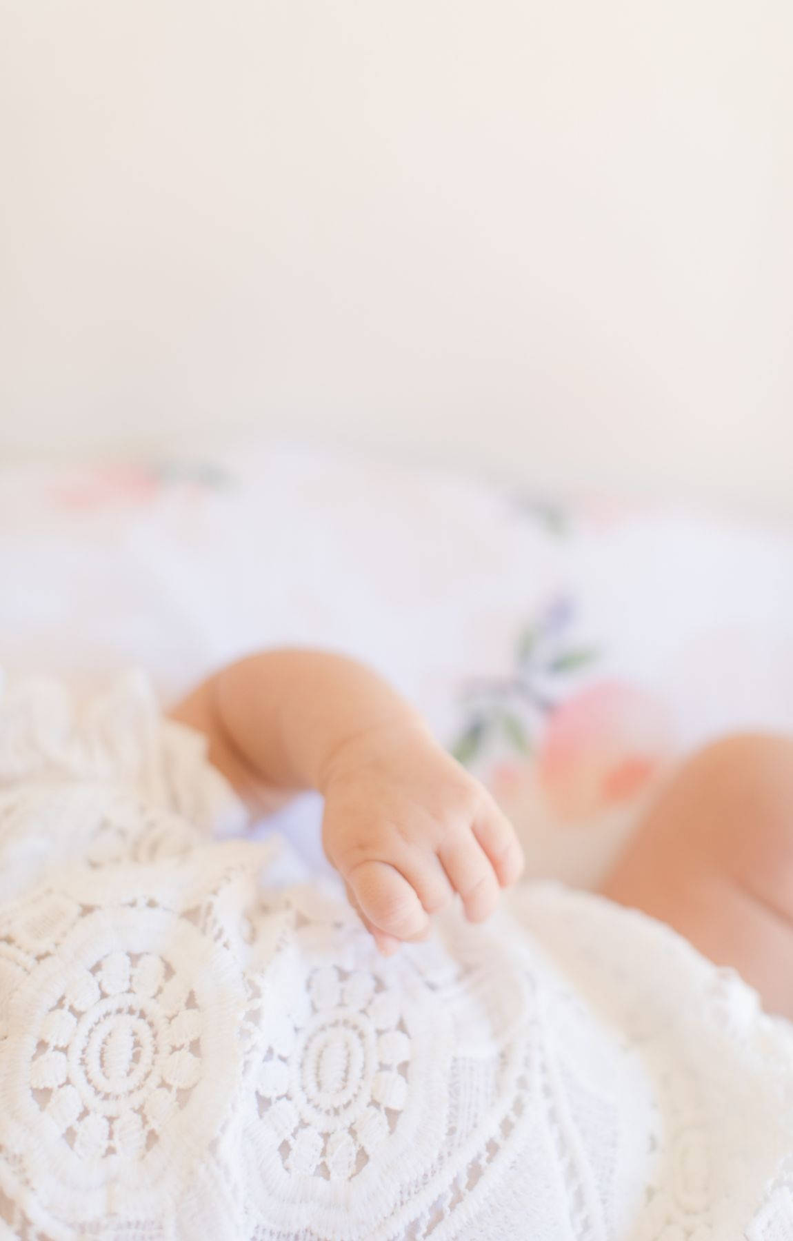 Baby Hand In White Baby Clothes Background