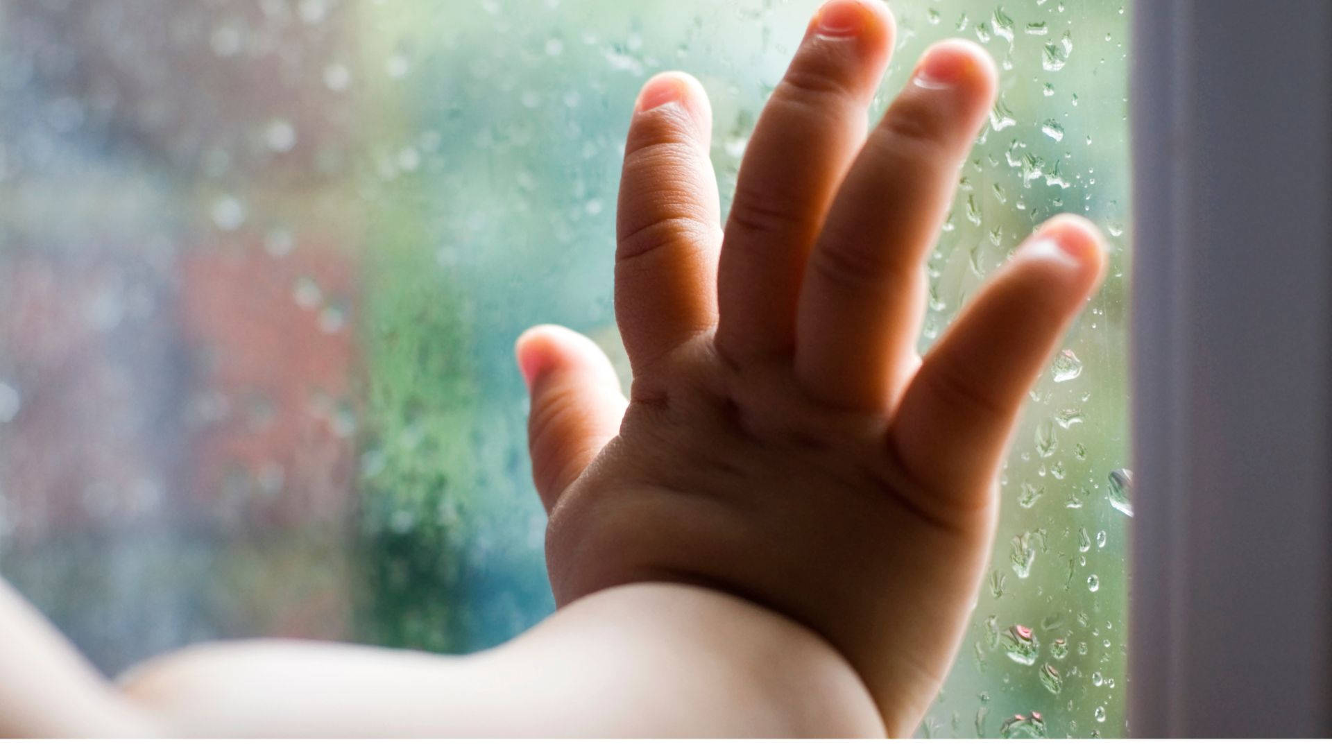 Baby Hand Leaning On Glass Panel Background