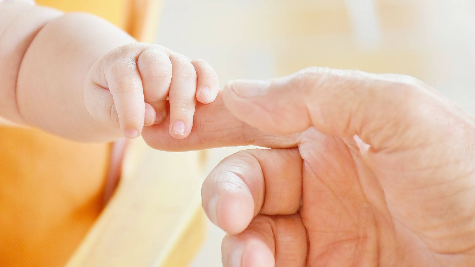 Baby Hand Reaching For Parent's Hand Background