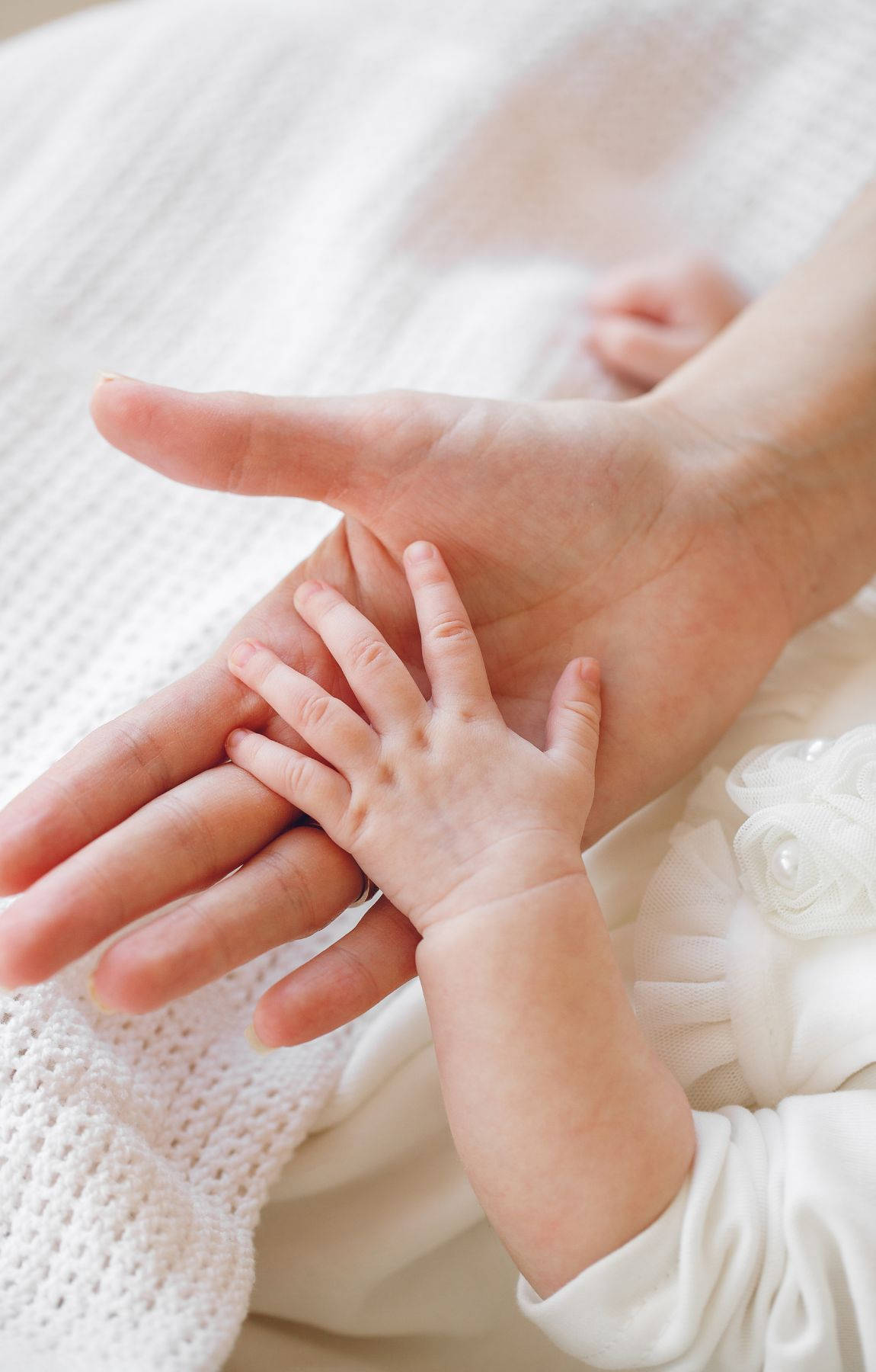 Baby Hand Resting On A Hand Background