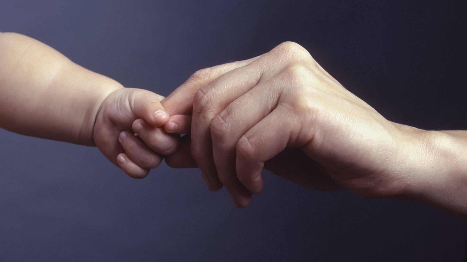 Baby Hand Shaking Mother's Finger Background