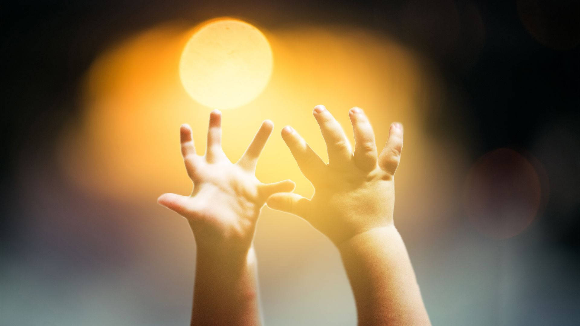 Baby Hands Reaching A Yellow Light Background