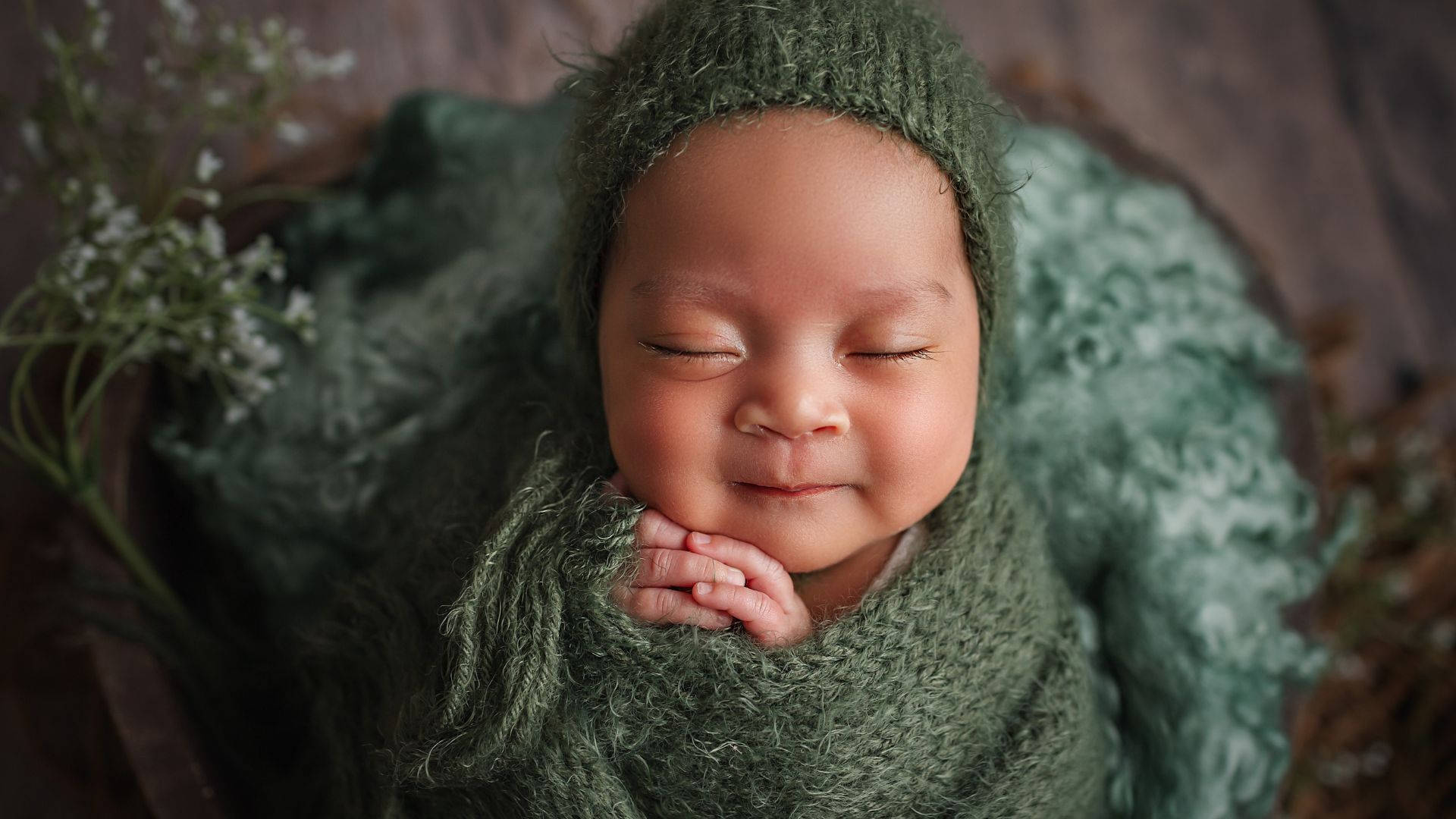 Baby Photography In Green Crochet Clothes Background