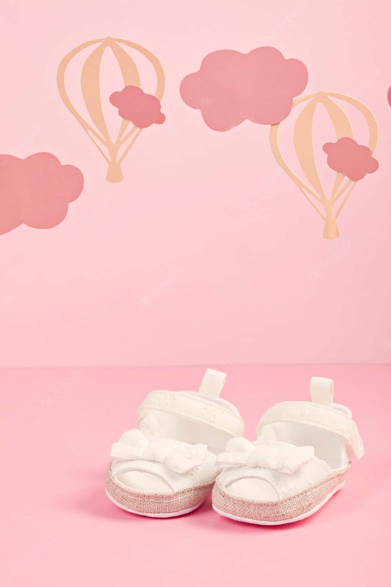 Baby Shoes With Hot Air Balloons On A Pink Background Background