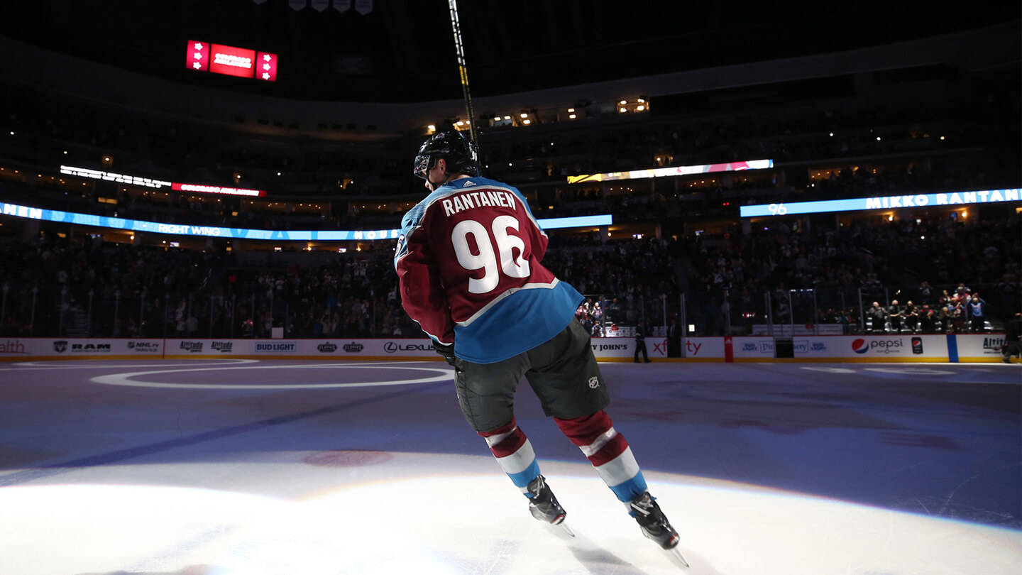 Back Shot Of Mikko Rantanen Leaning To The Left While Holding Hockey Stick Background