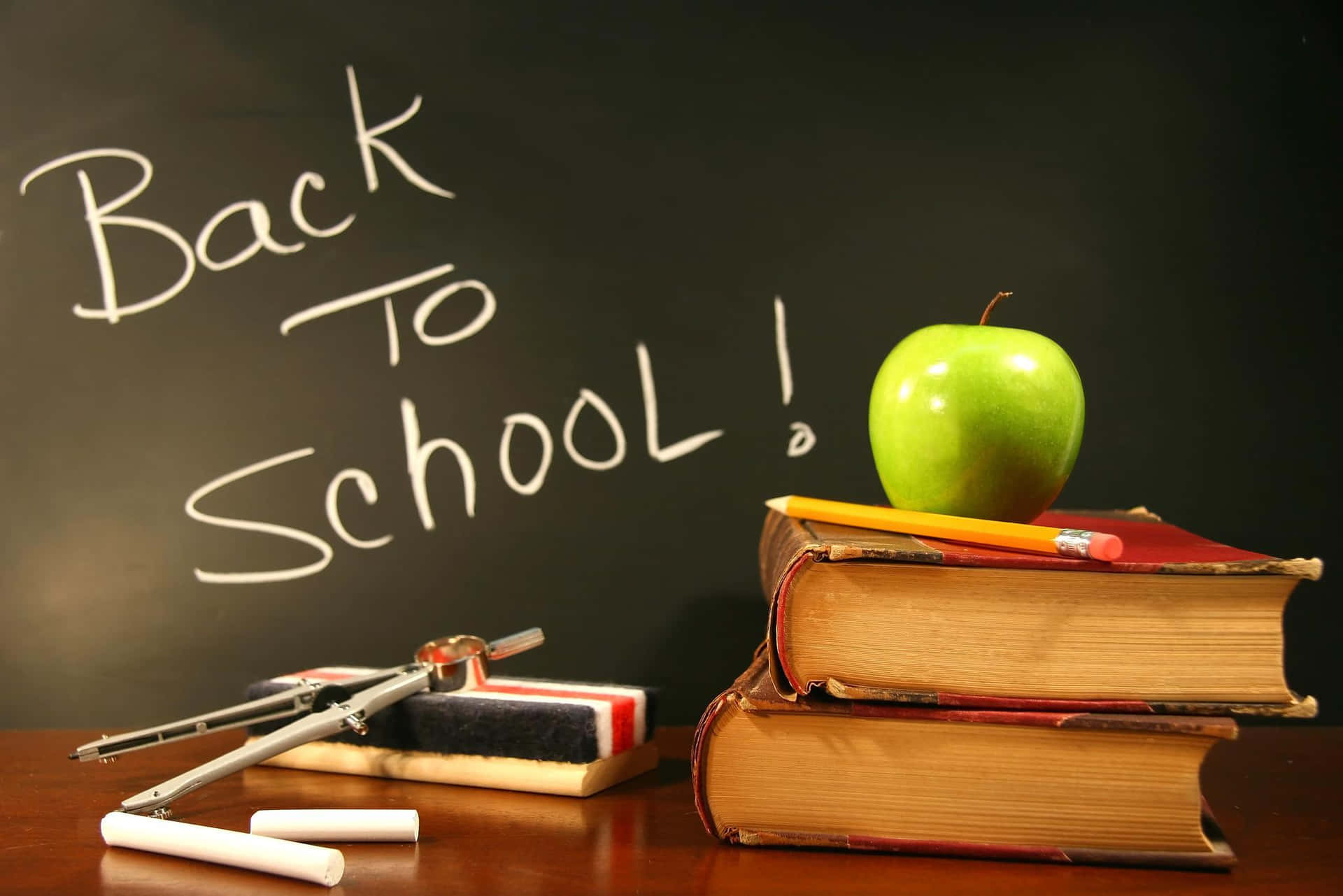 Back To School - A Stack Of Books And An Apple Background