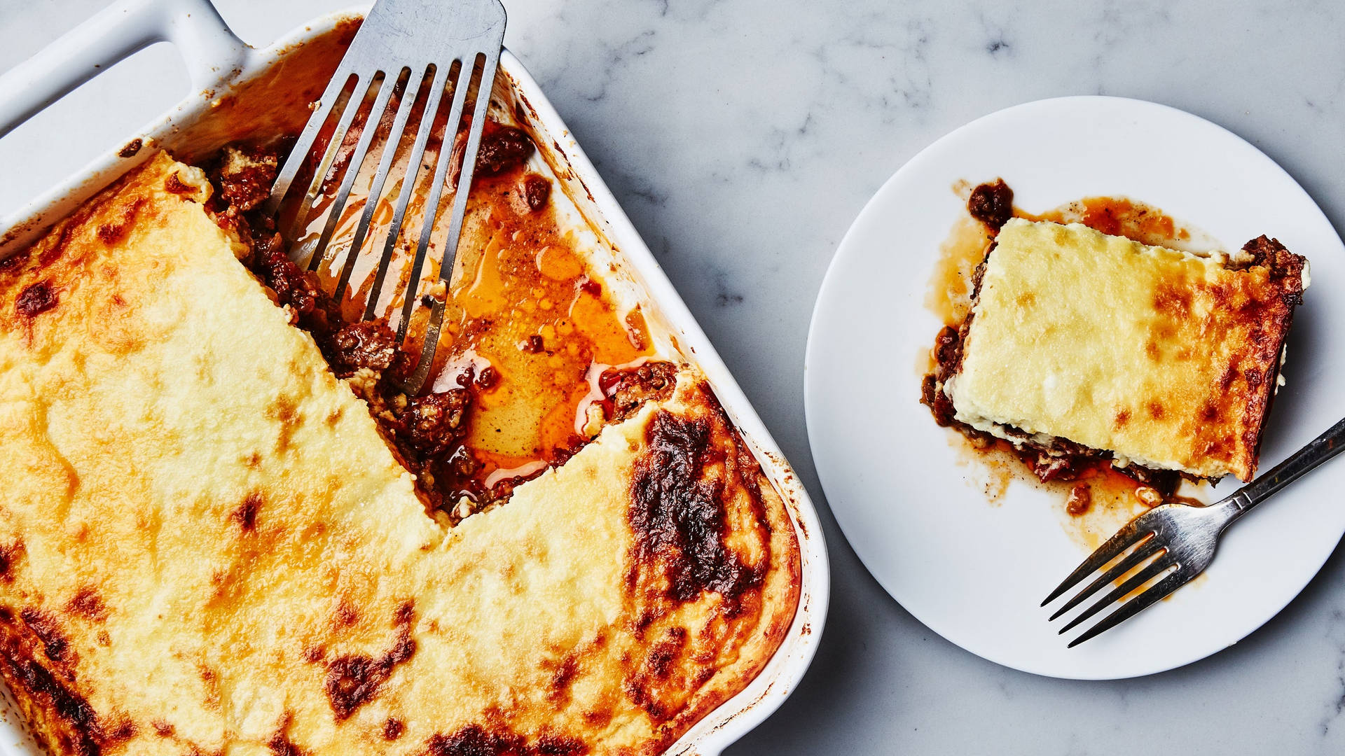 Baked Moussaka On A Serving Tray And White Ceramic Background