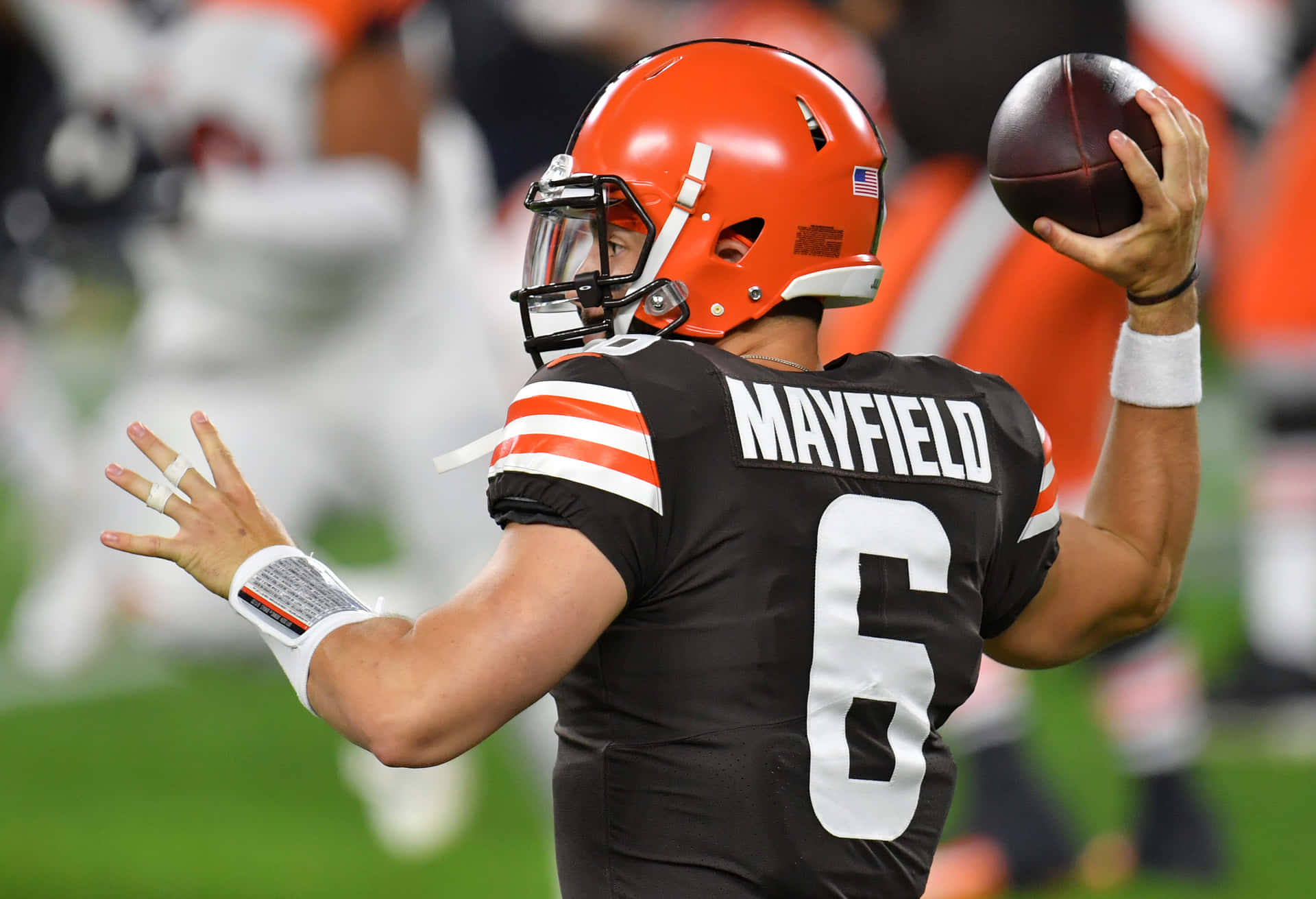 Baker Mayfield Black Uniform Throws A Ball Background