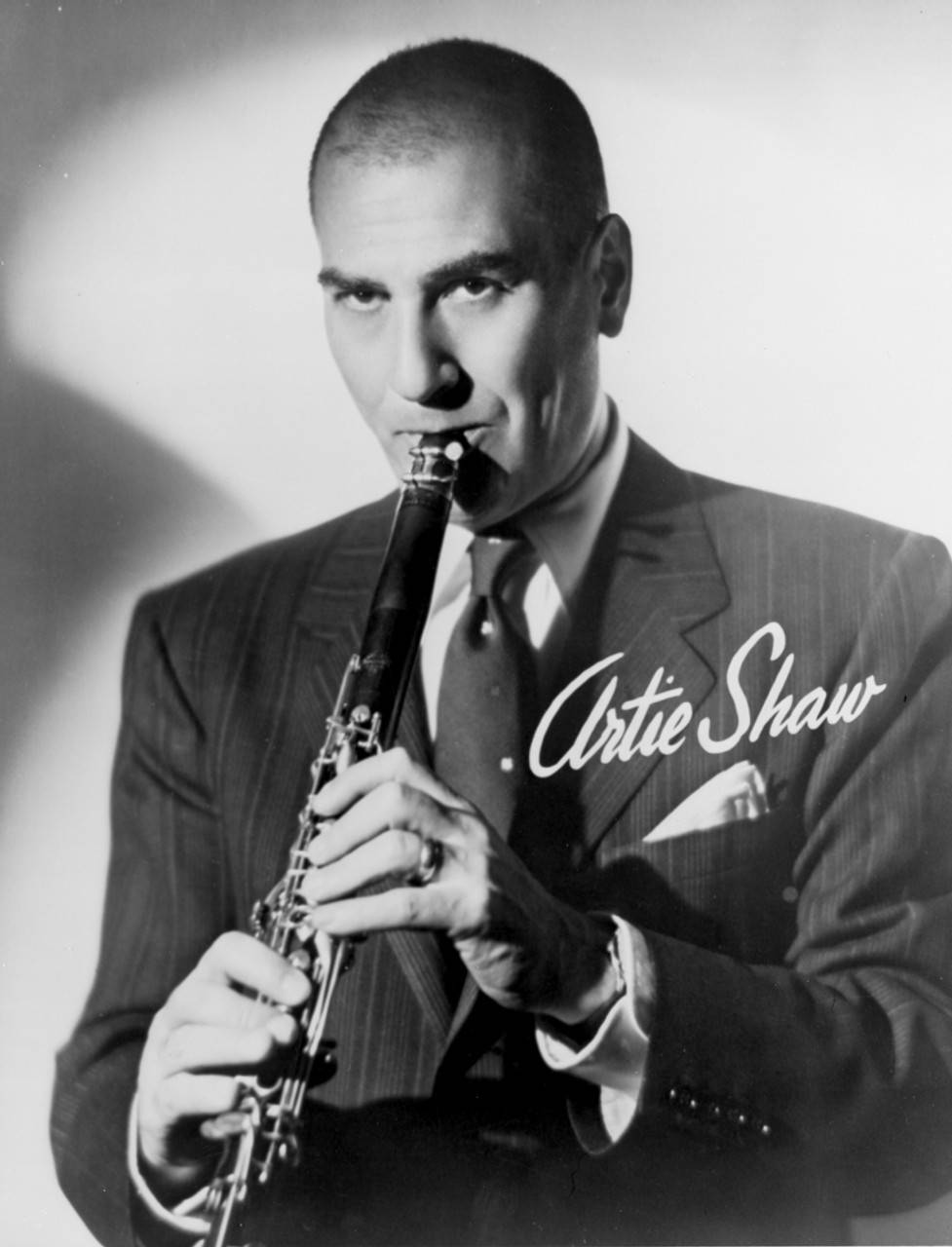 Bald Artie Shaw Playing Clarinet In Greyscale Background