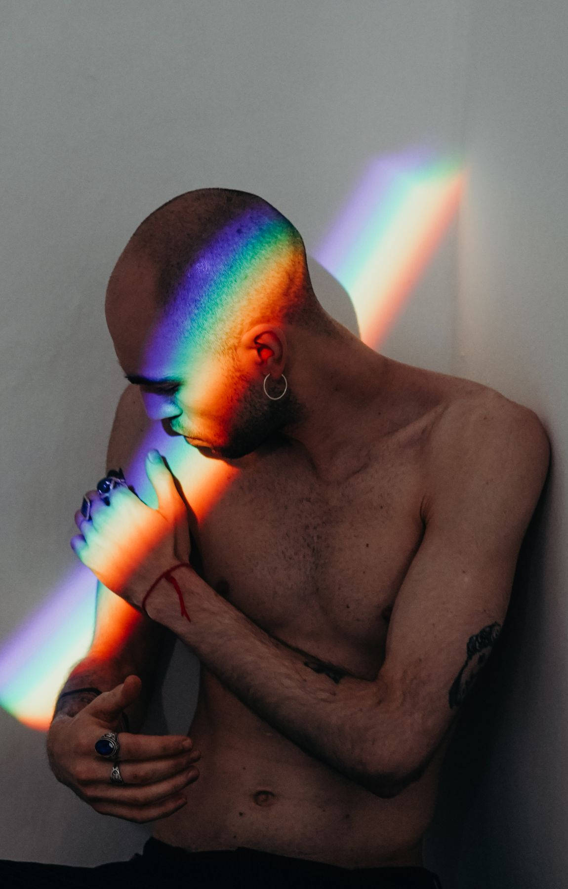 Bald Man Against A Rainbow Ray Of Light Background