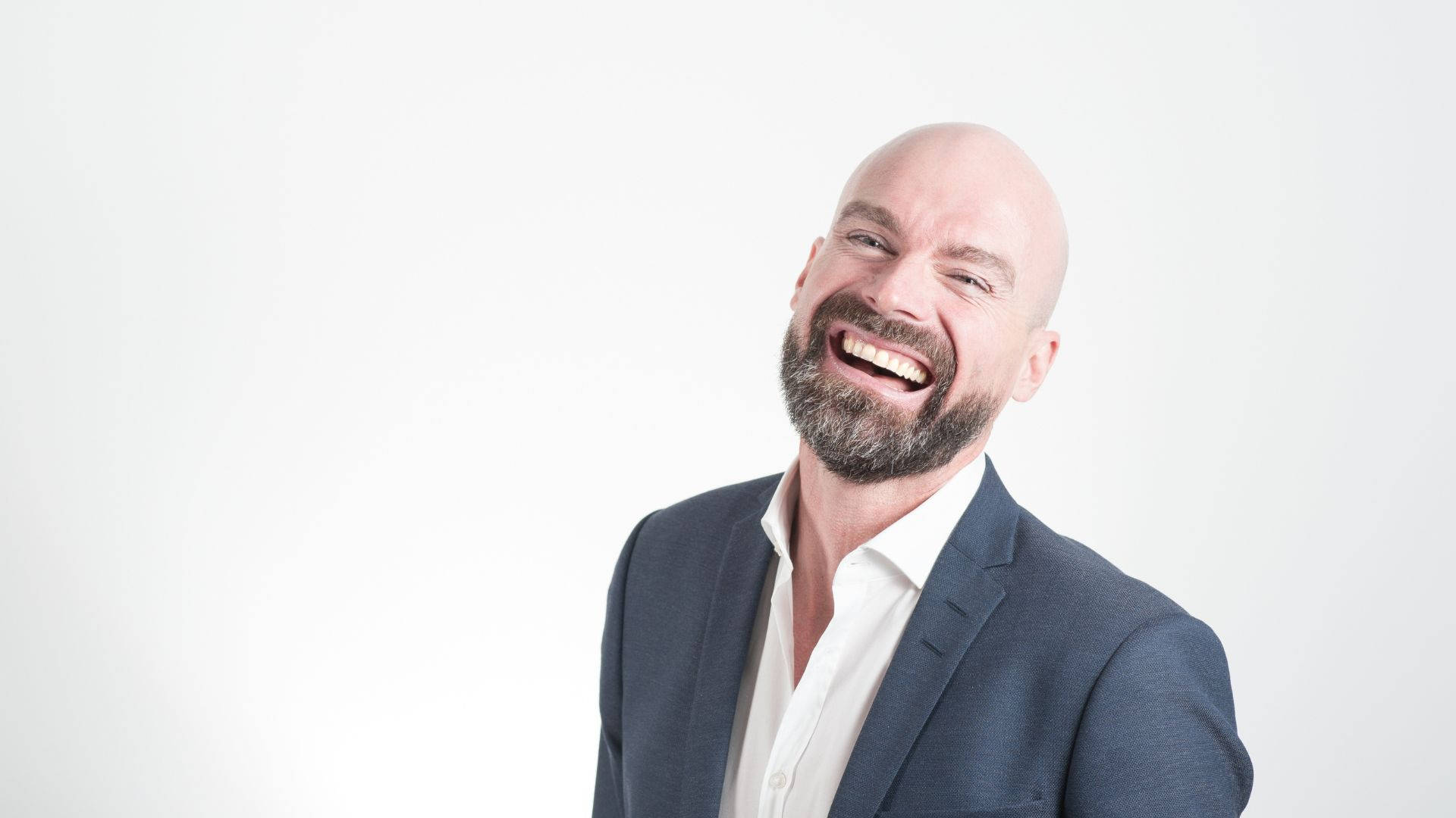 Bald Man Wearing A Black Suit Background