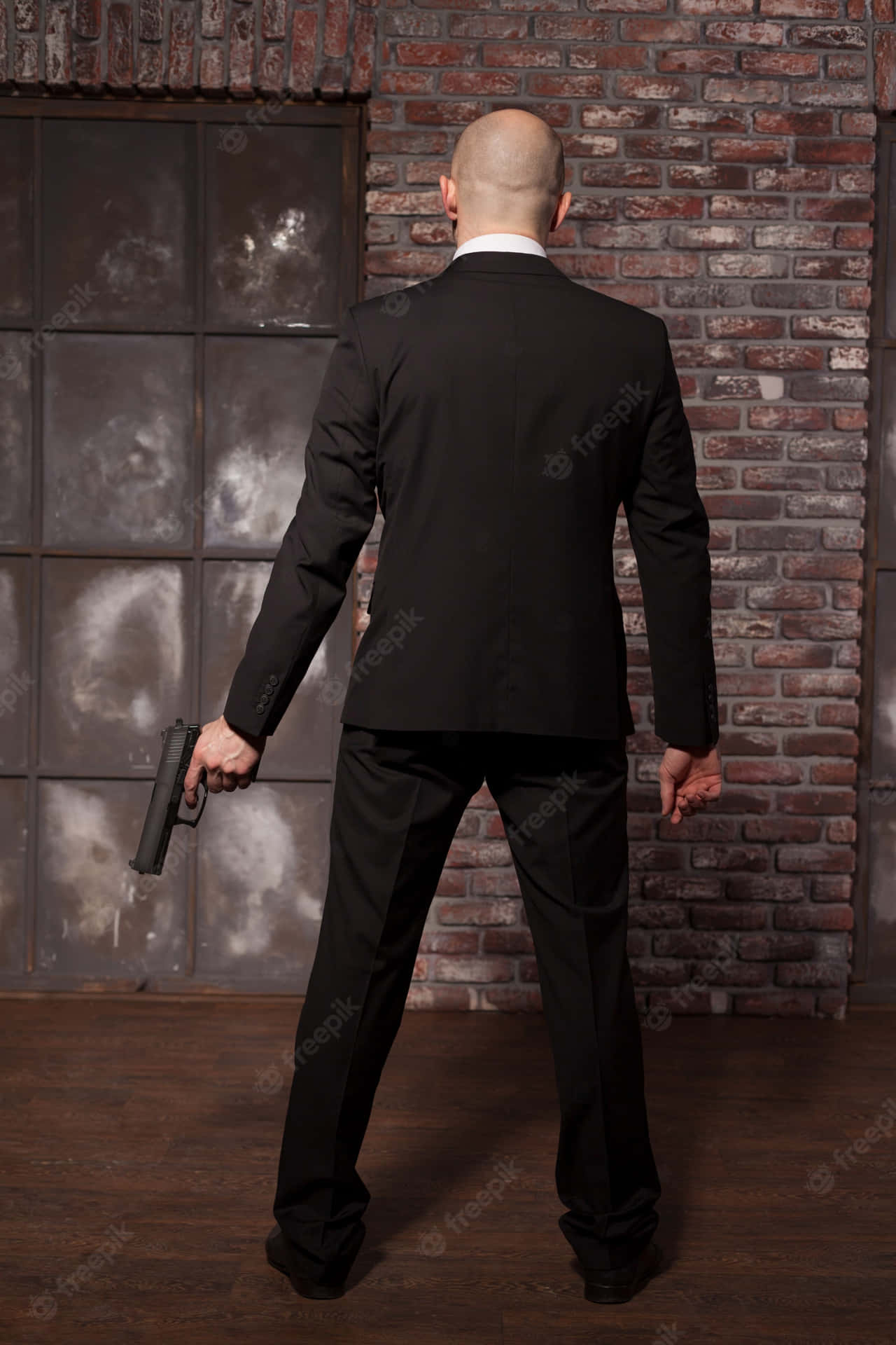 Bald Manin Suit Holding Gun Background