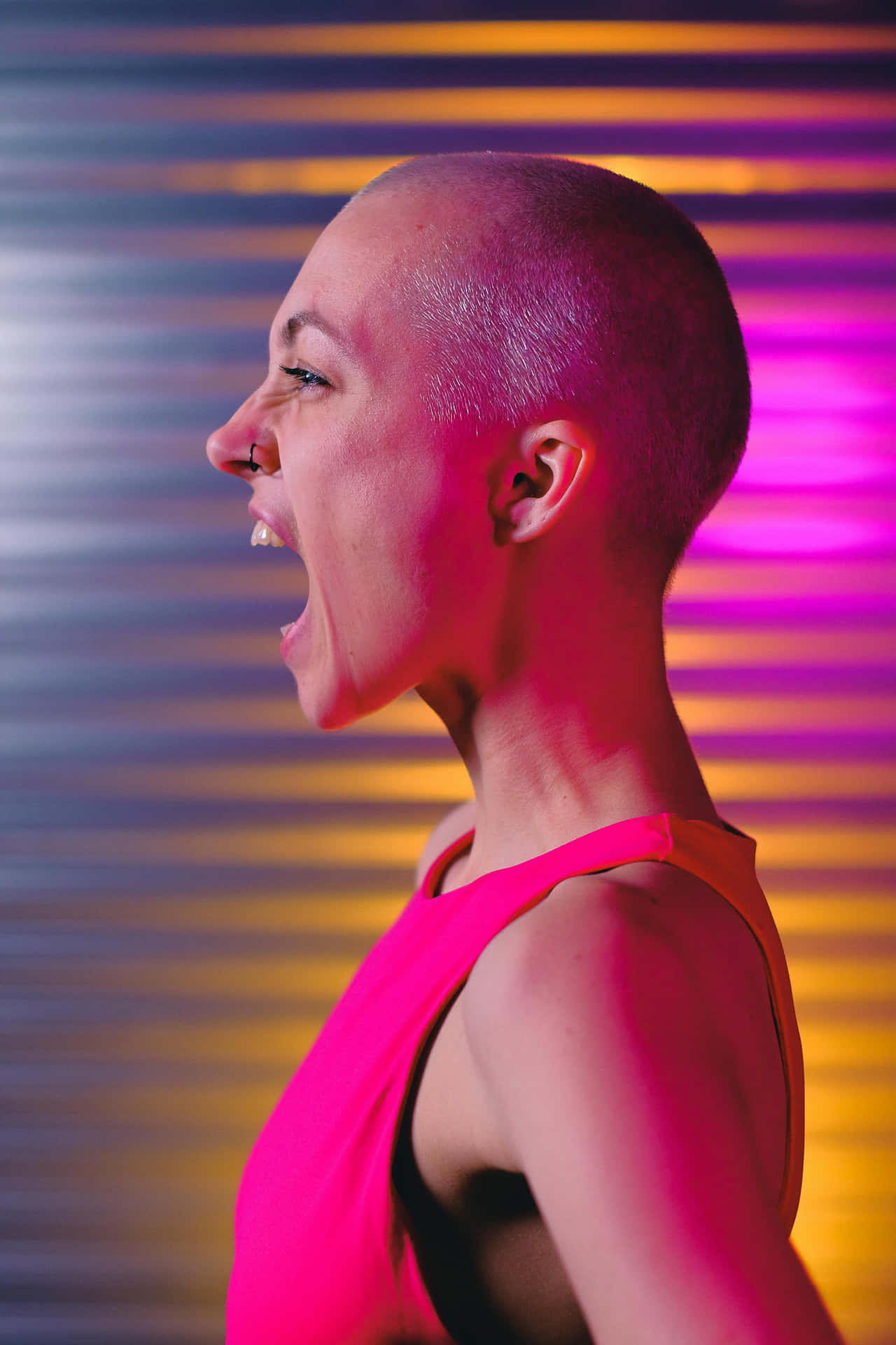 Bald Woman Laughing Against Colorful Background Background
