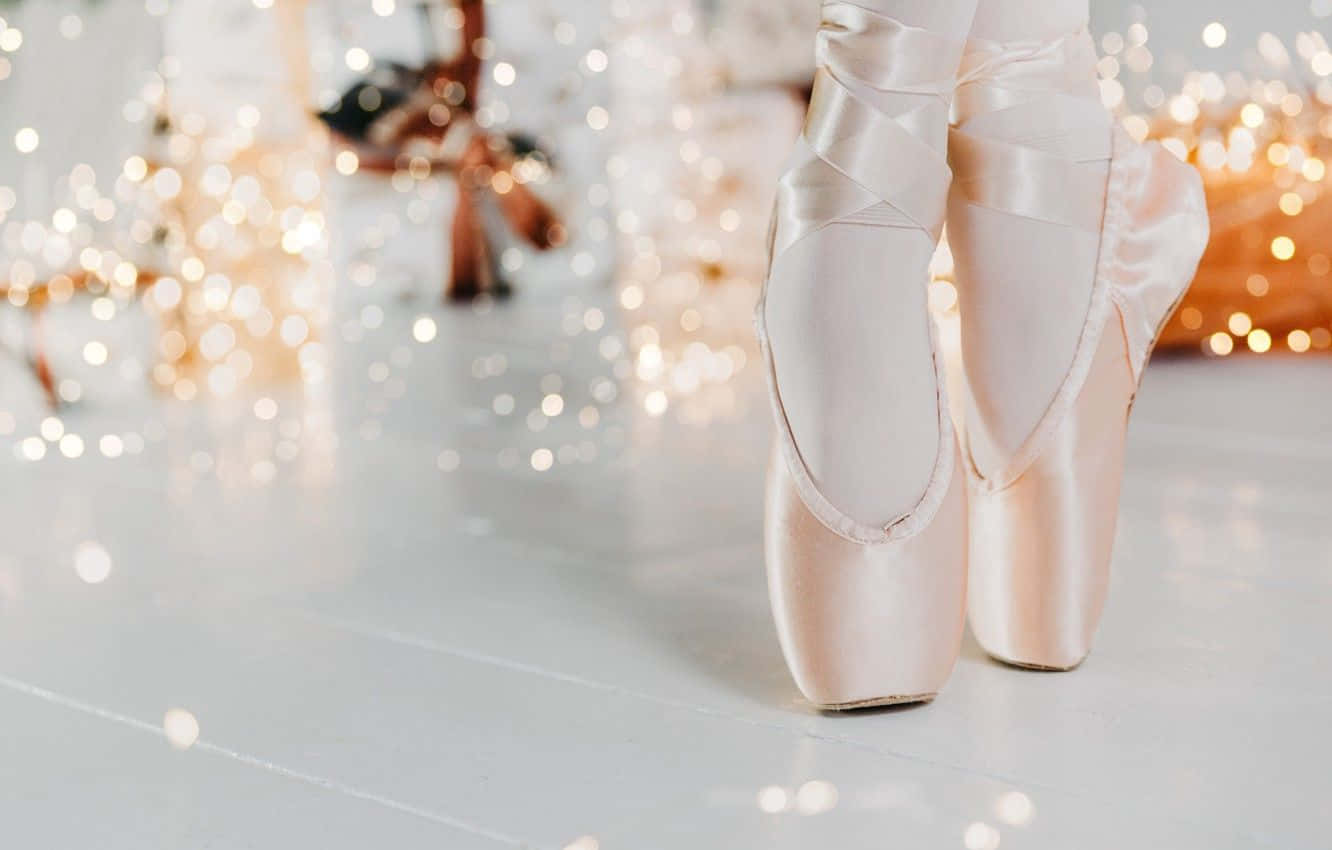 Ballet Shoes In A White Background With Lights Background
