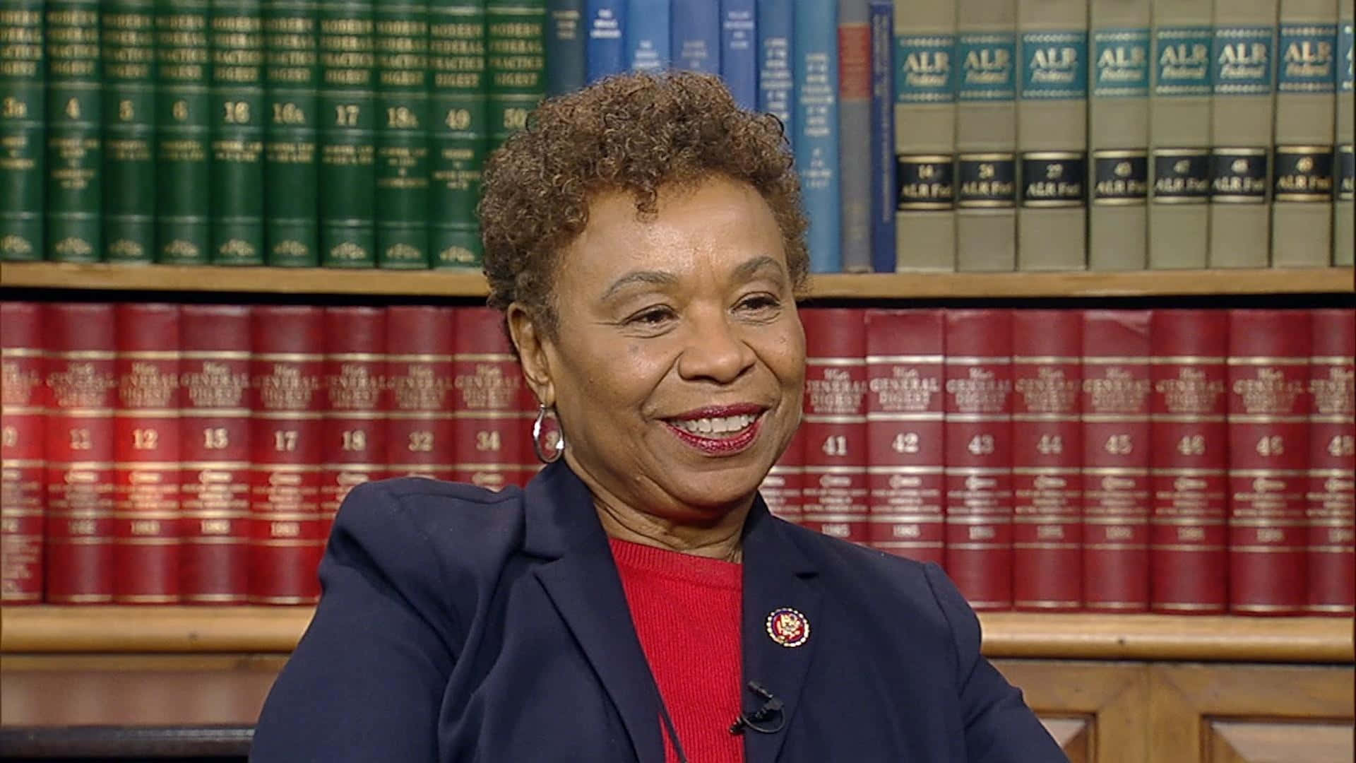 Barbara Lee Engaged In Reading At The Library Background