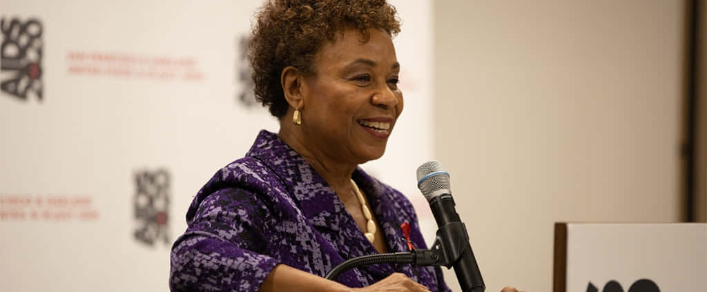 Barbara Lee Smiling During Press Conference Background
