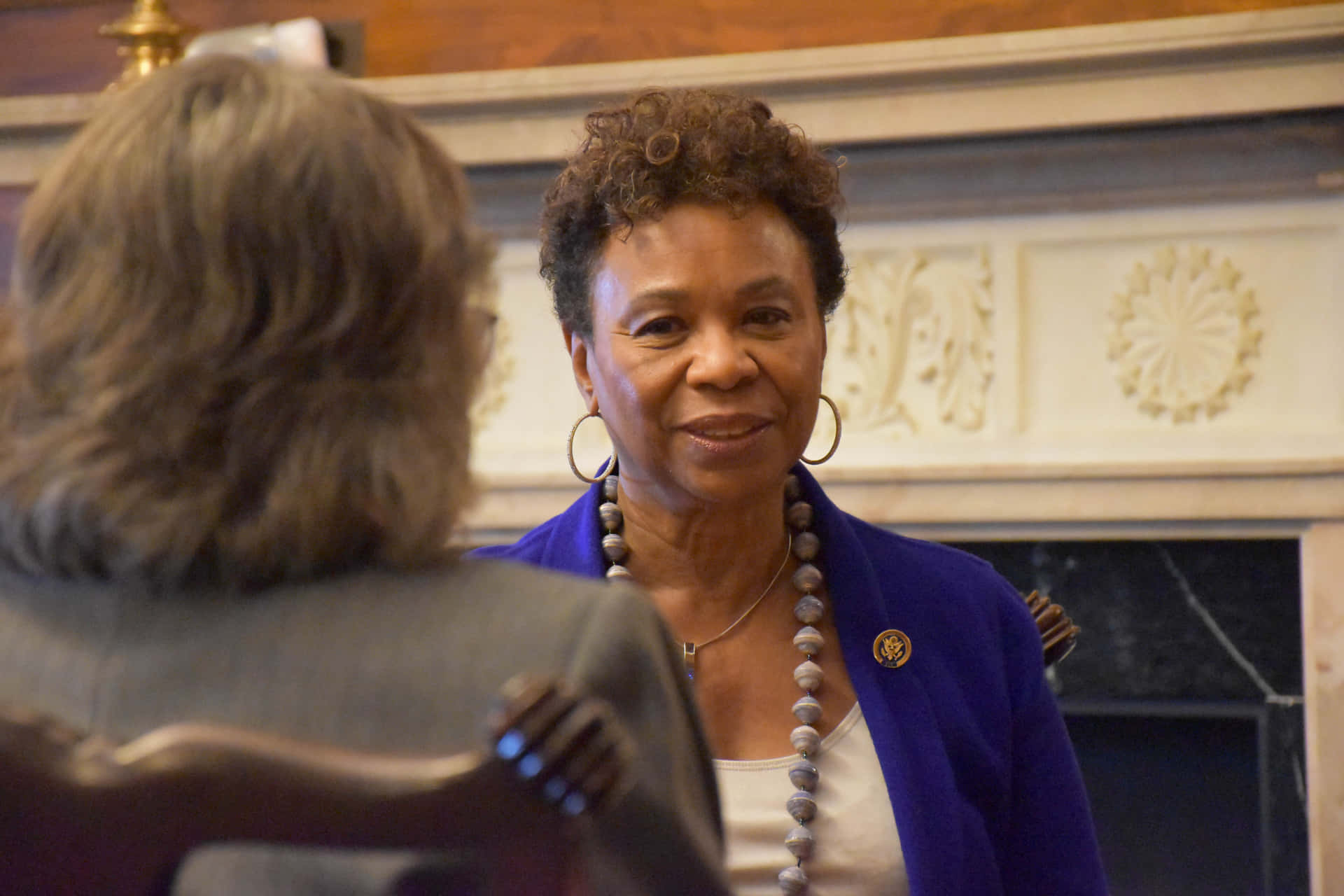 Barbara Lee Talking To Woman Background