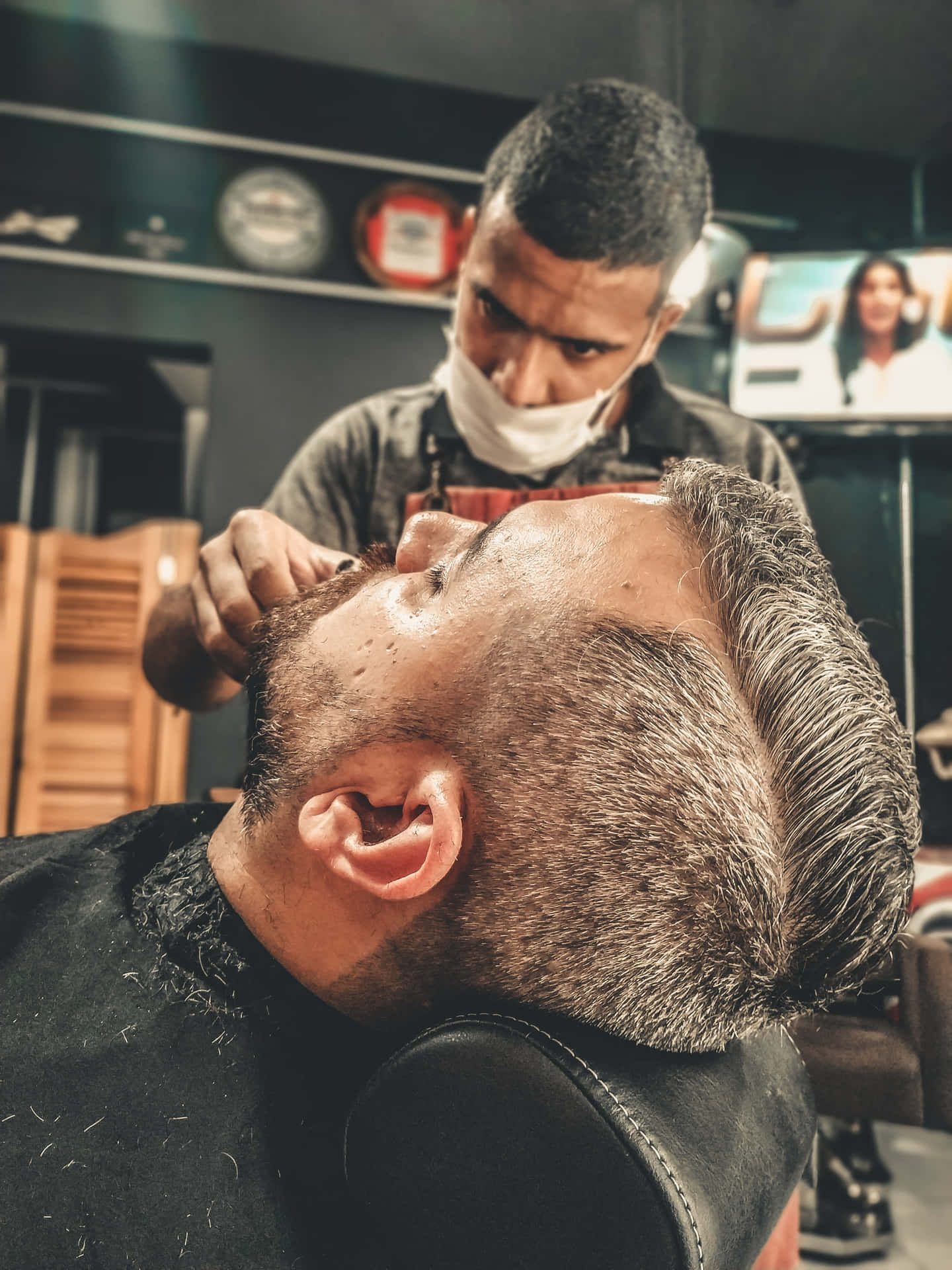 Barber Cutting The Hair Of The Customer With Face Mask Background